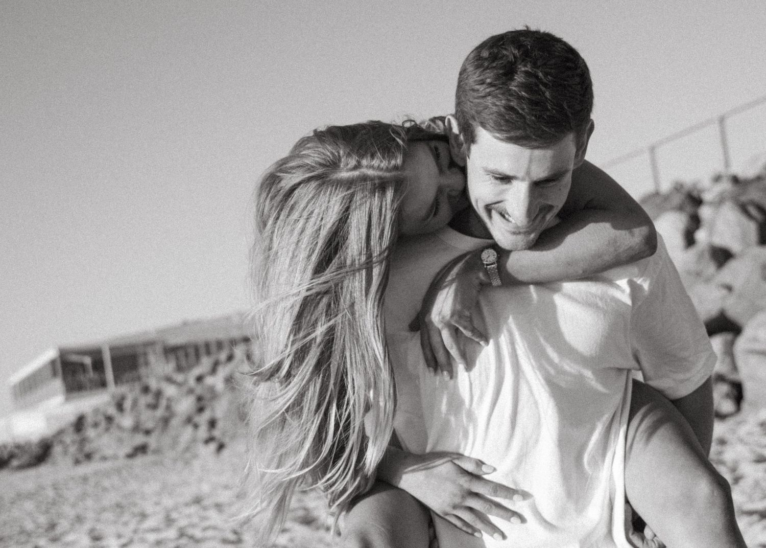 Couples kissing at a photoshoot at an Adelaide beach at sunset, golden hour.