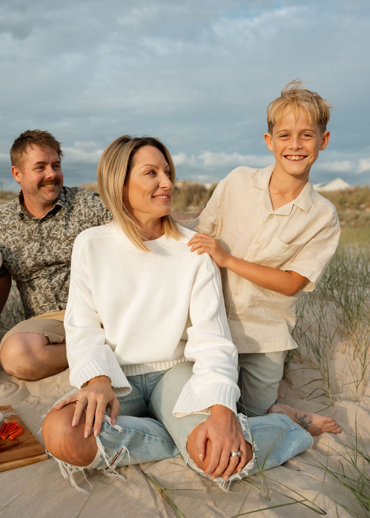 A family photography session at the beach at sunset with their 2 children.