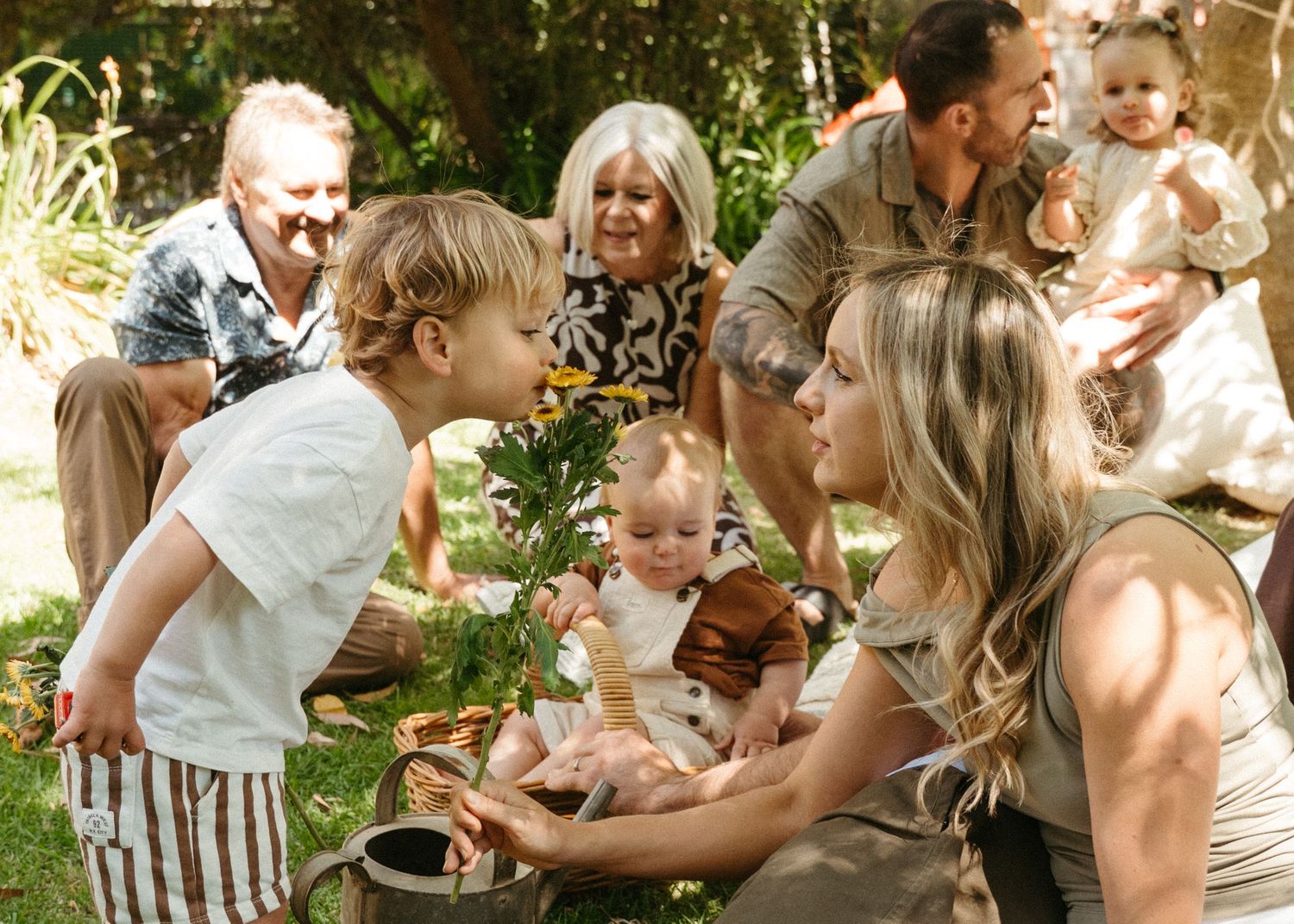 An extended family photoshoot at their family home with the children and grandchildren laughing and having fun together.