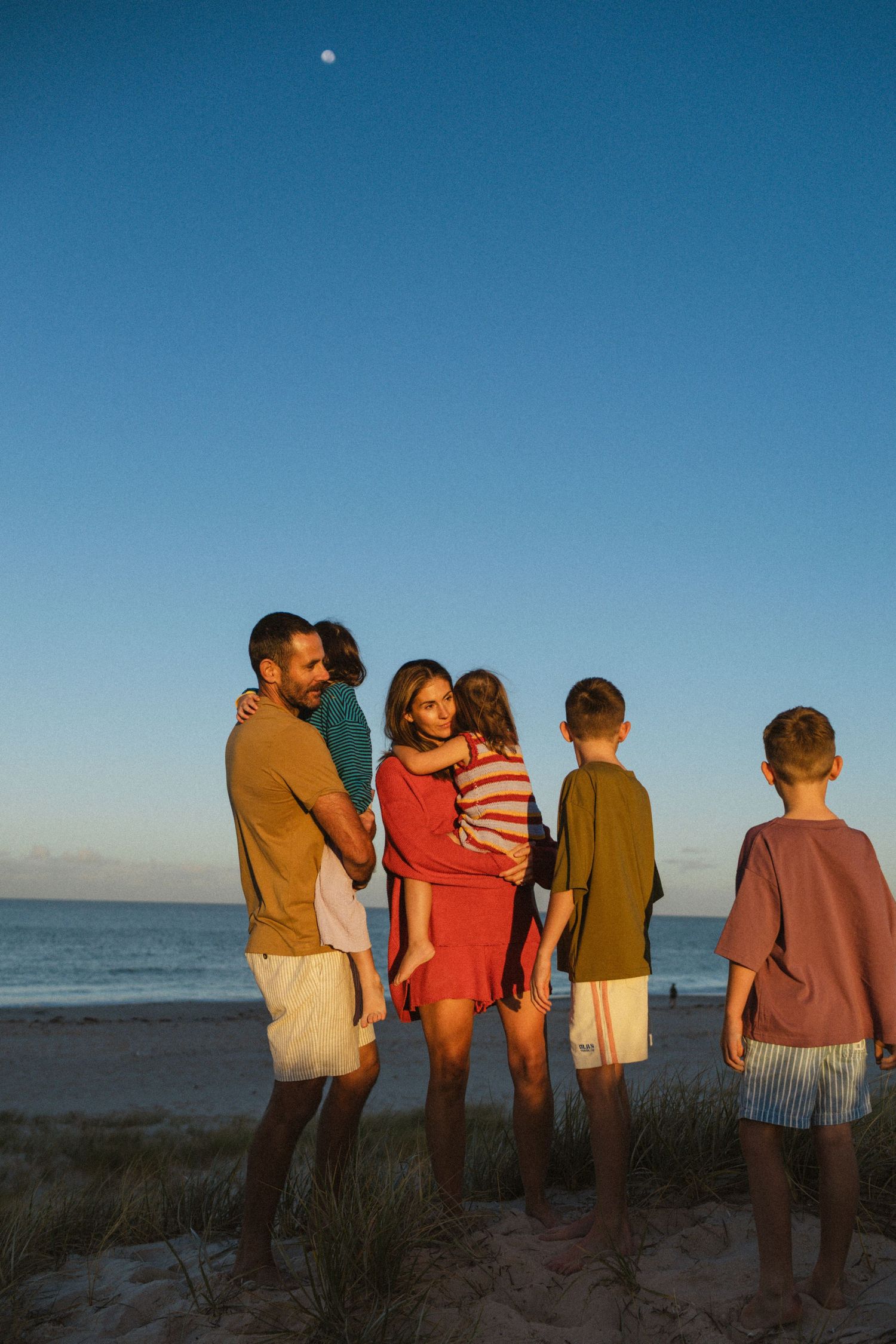 A family photography session at the beach at sunrise with their 4 children.