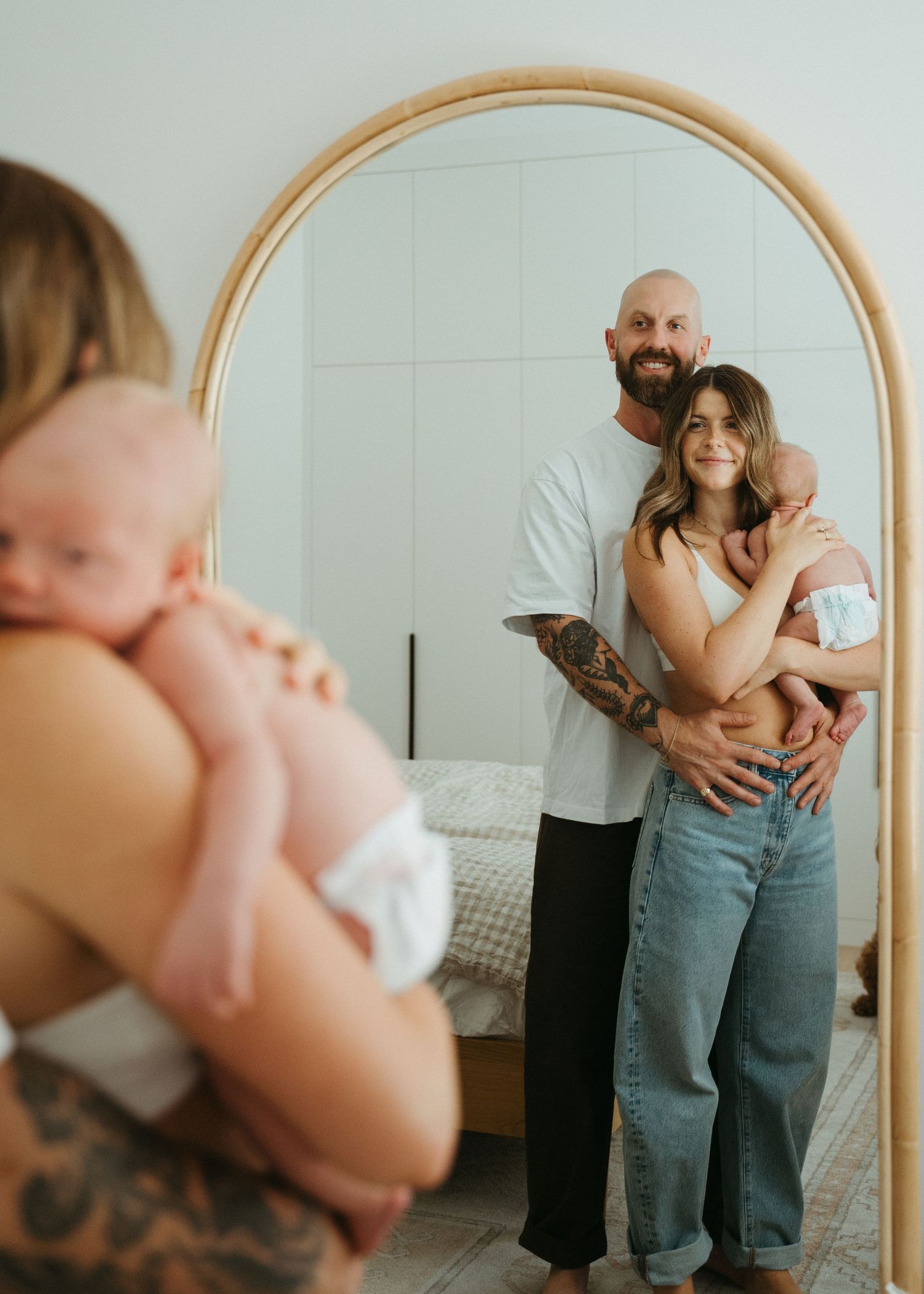 A mother and her newborn baby at a newborn photography session at home.