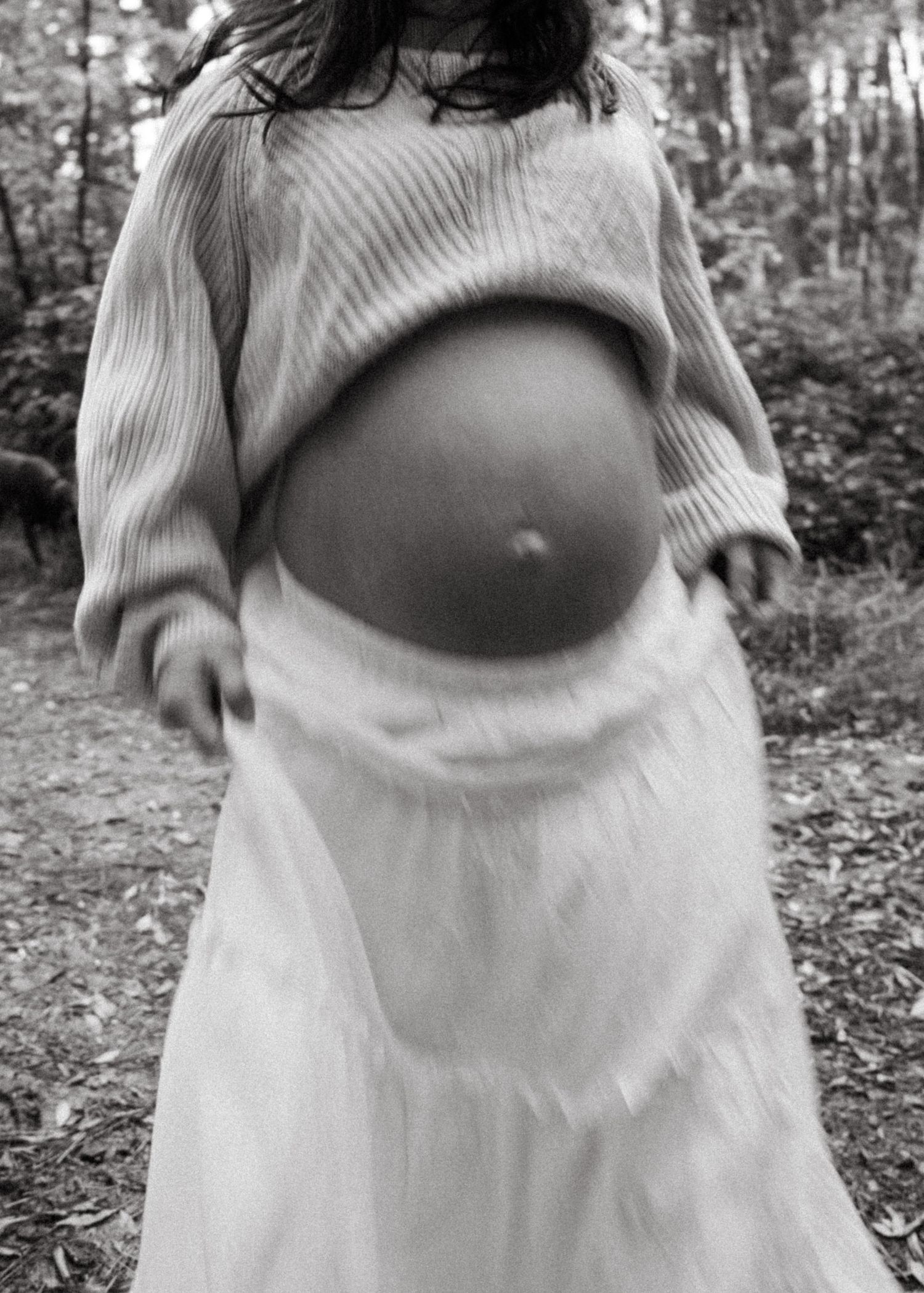 An Adelaide couple at a maternity photoshoot in the forest at golden hour.