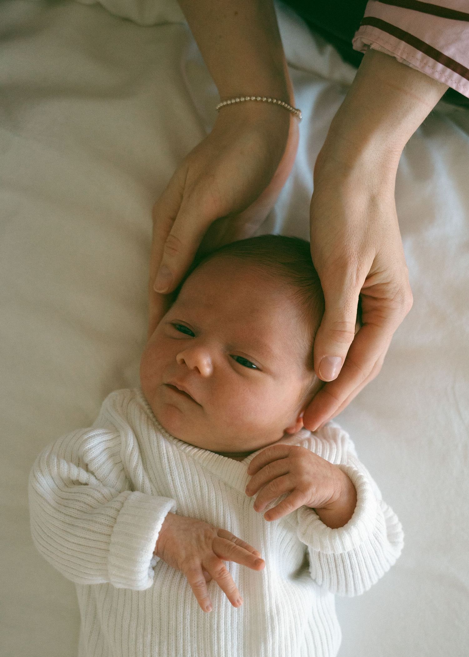 A newborn photography session at a family home with their 2 week old baby girl.