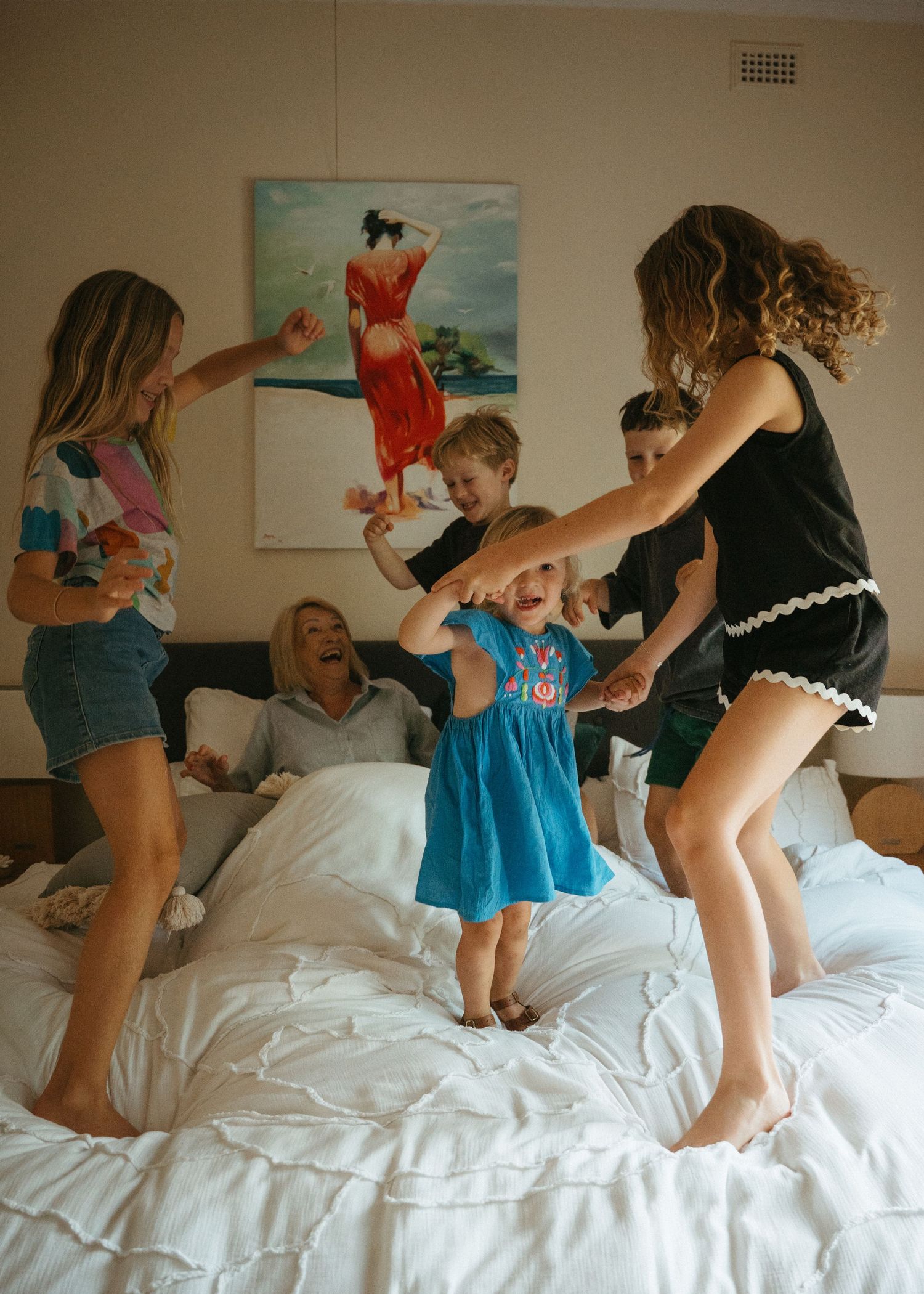 An extended family photoshoot at their family home with the children and grandchildren laughing and having fun together.
