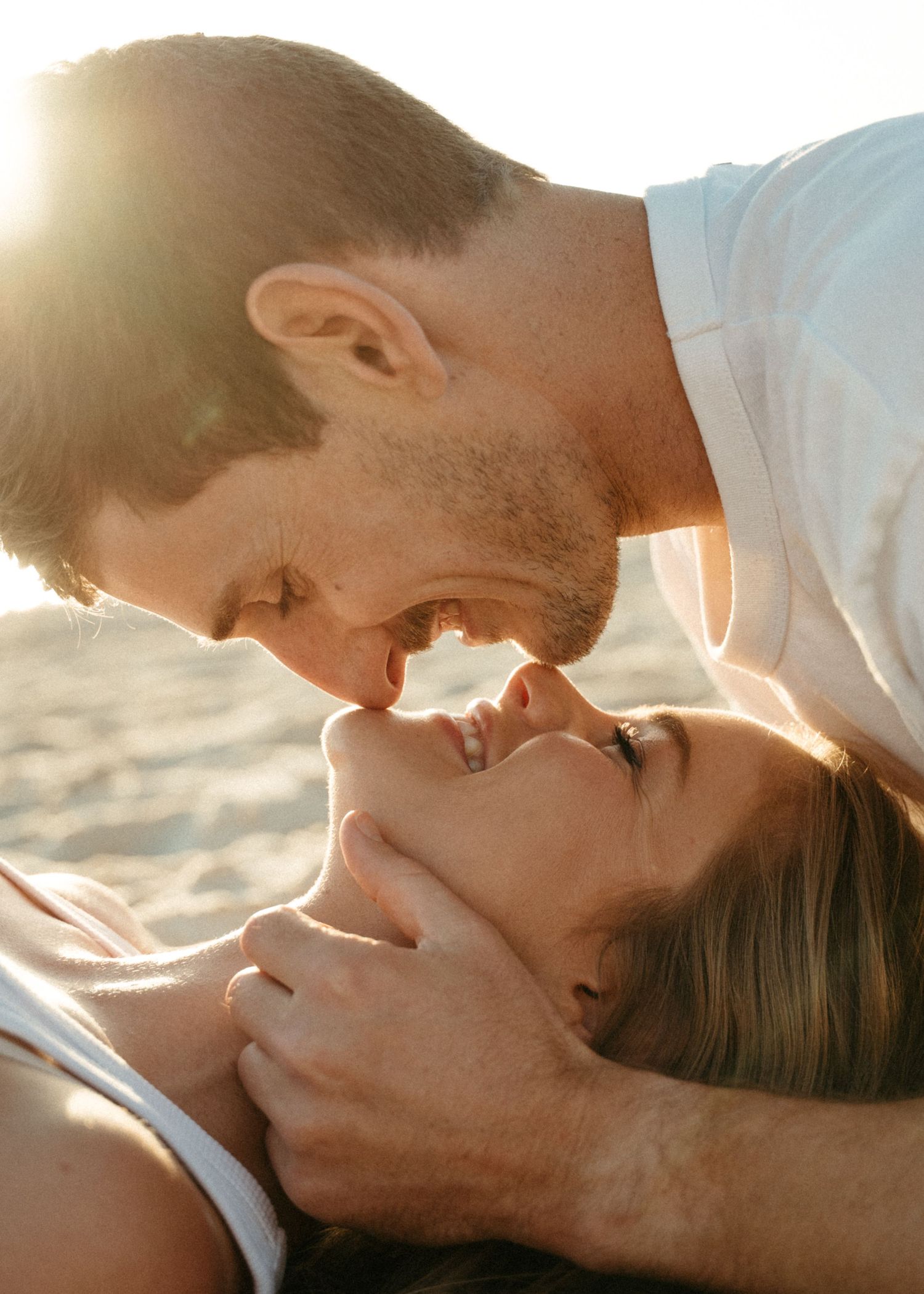 Couples kissing at a photoshoot at an Adelaide beach at sunset, golden hour.