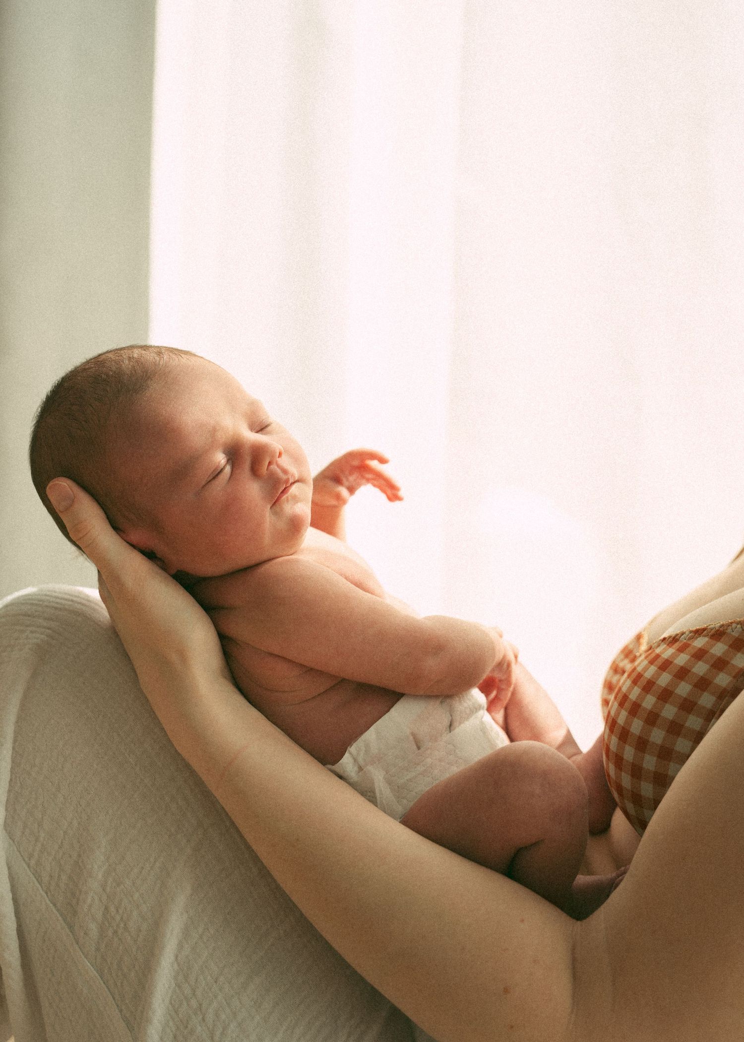A newborn photography session at a family home with their 2 week old baby girl.
