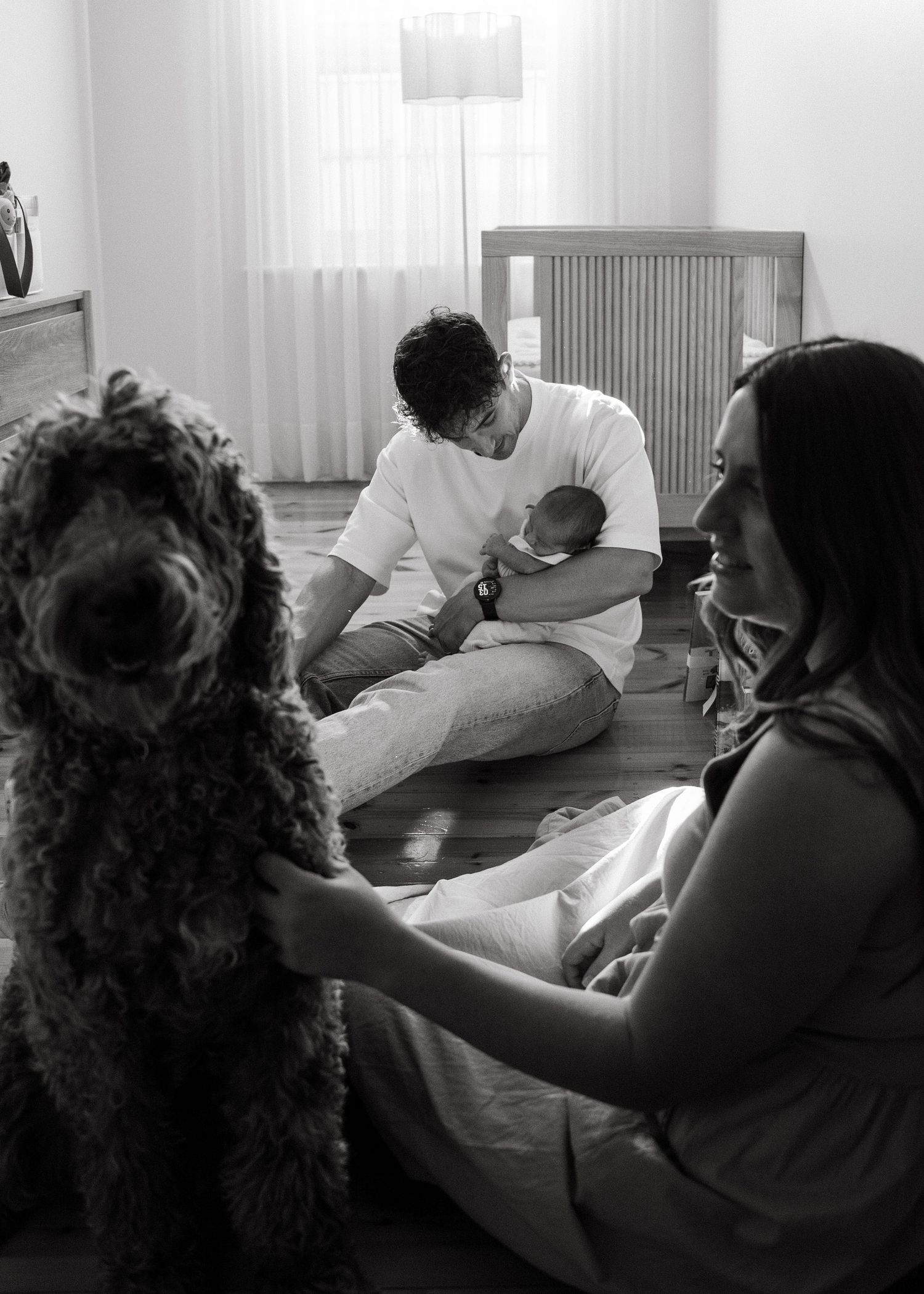 A newborn photography session at a family home with their 2 week old baby boy and dog.