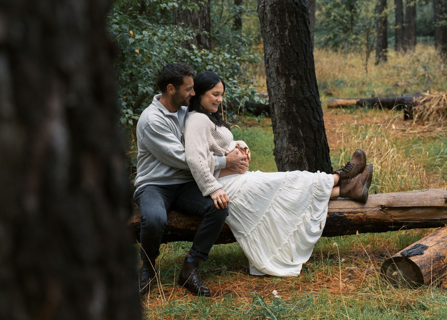 An Adelaide couple at a maternity photoshoot in the forest at golden hour.