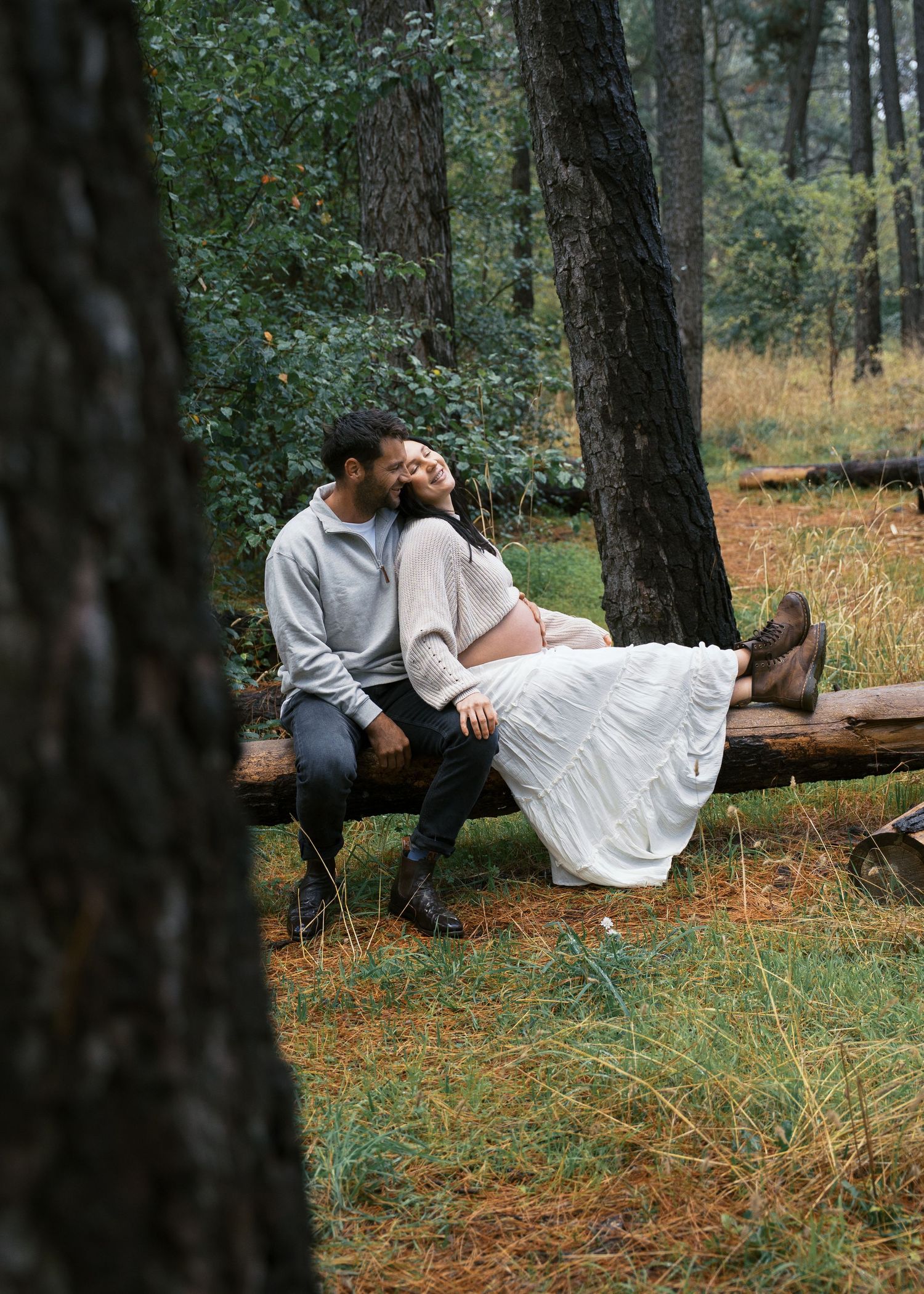 An Adelaide couple at a maternity photoshoot in the forest at golden hour.