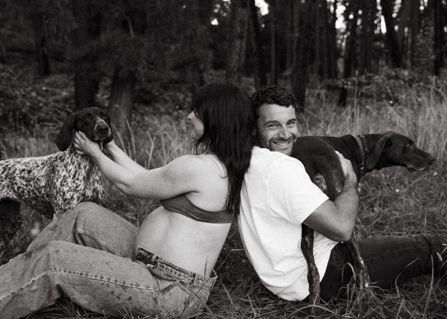 An Adelaide couple at a maternity photoshoot in the forest at golden hour.