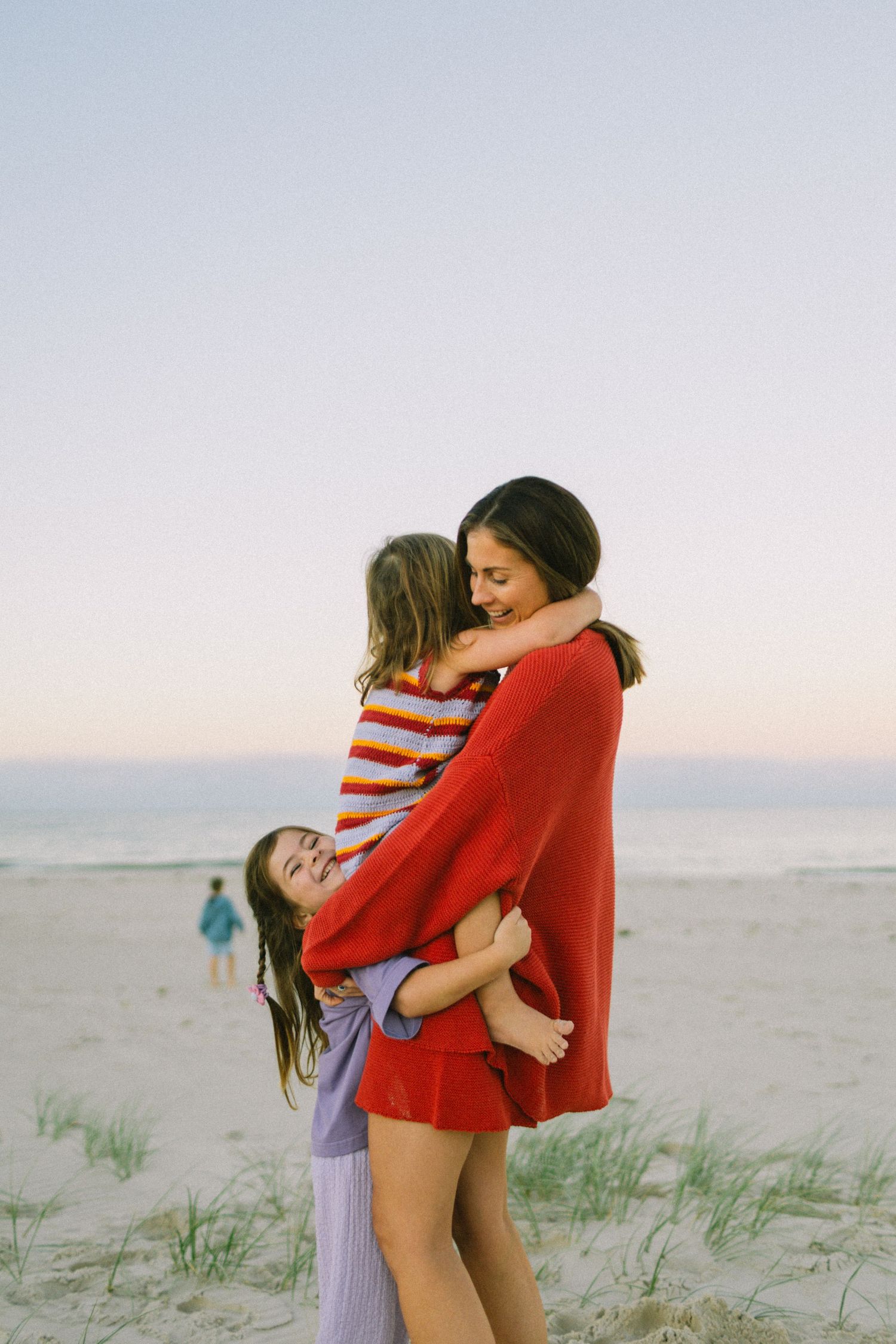 A family photography session at the beach at sunrise with their 4 children.