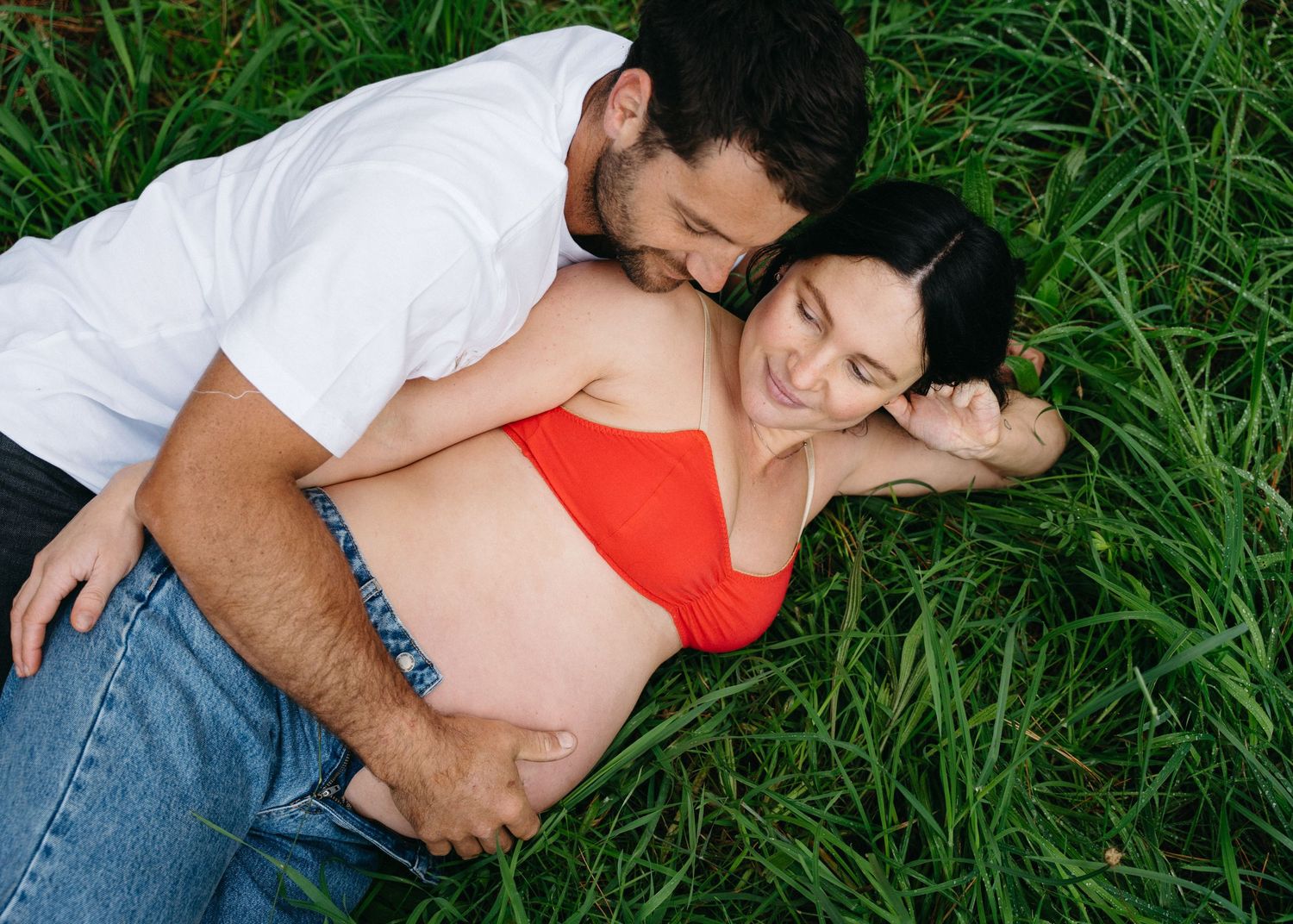 An Adelaide couple at a maternity photoshoot in the forest at golden hour.