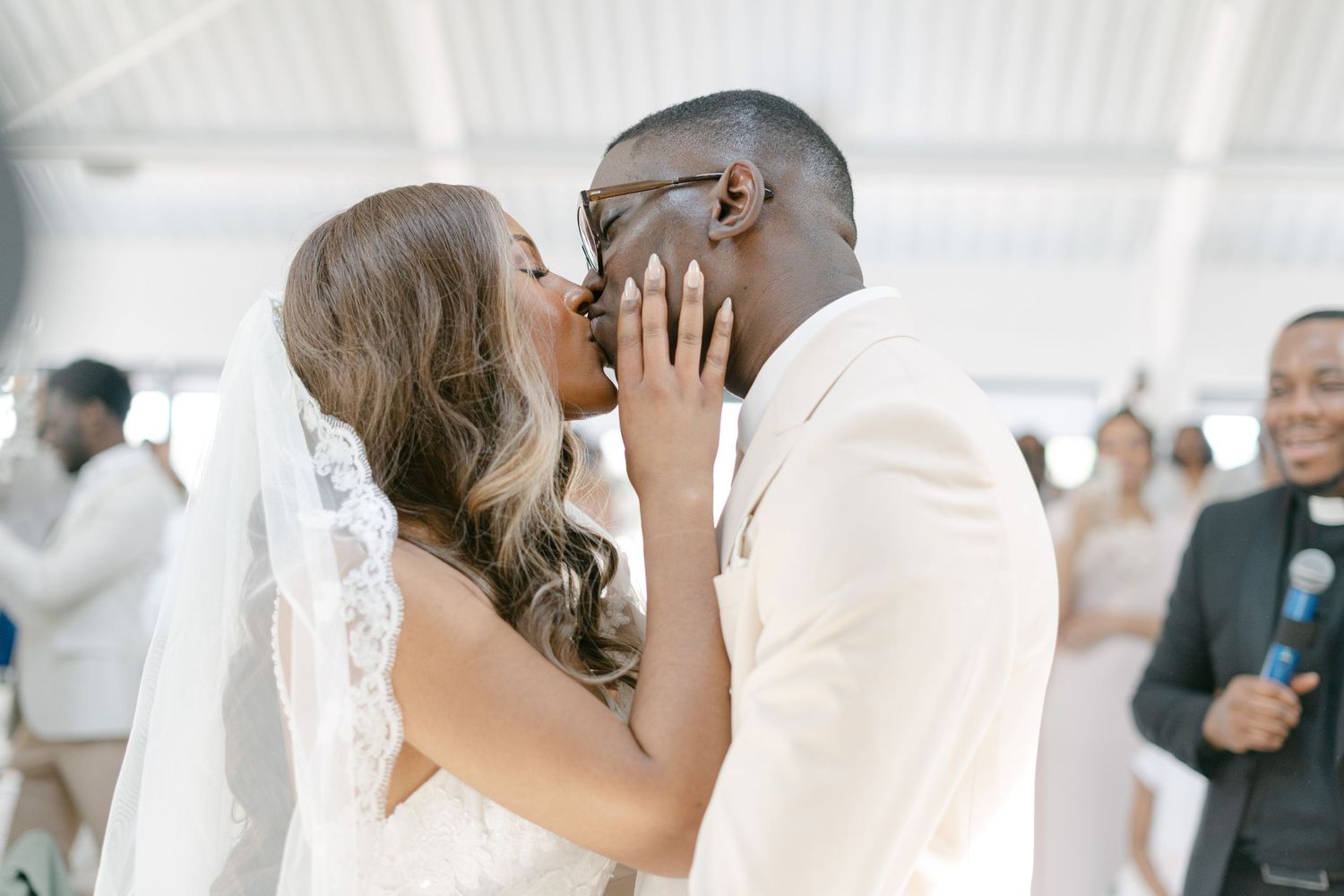 Emotional wedding celebration moments captured in bright indoor venue.