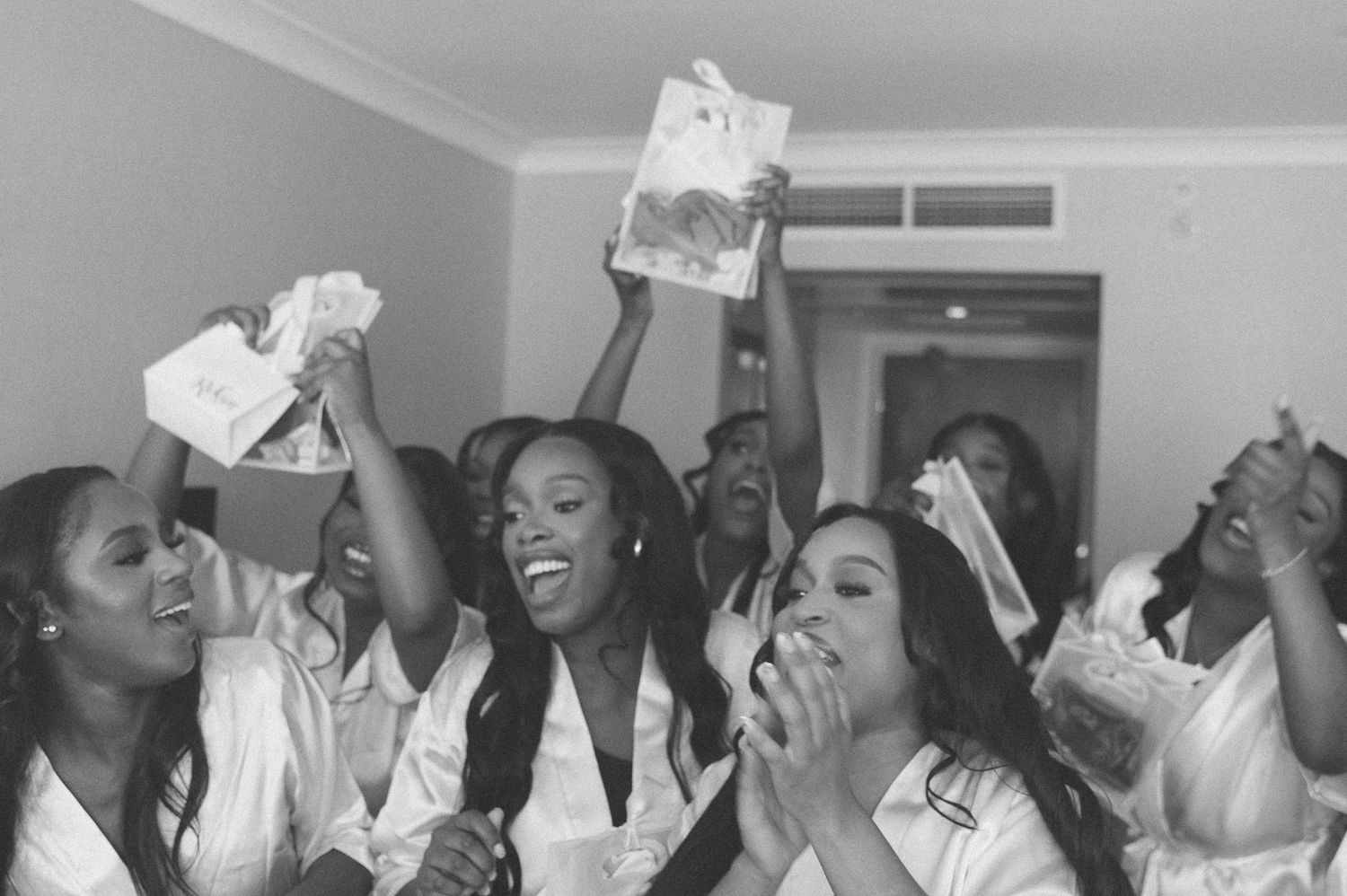 A joyful celebration with raised hands and laughter at a festive gathering.