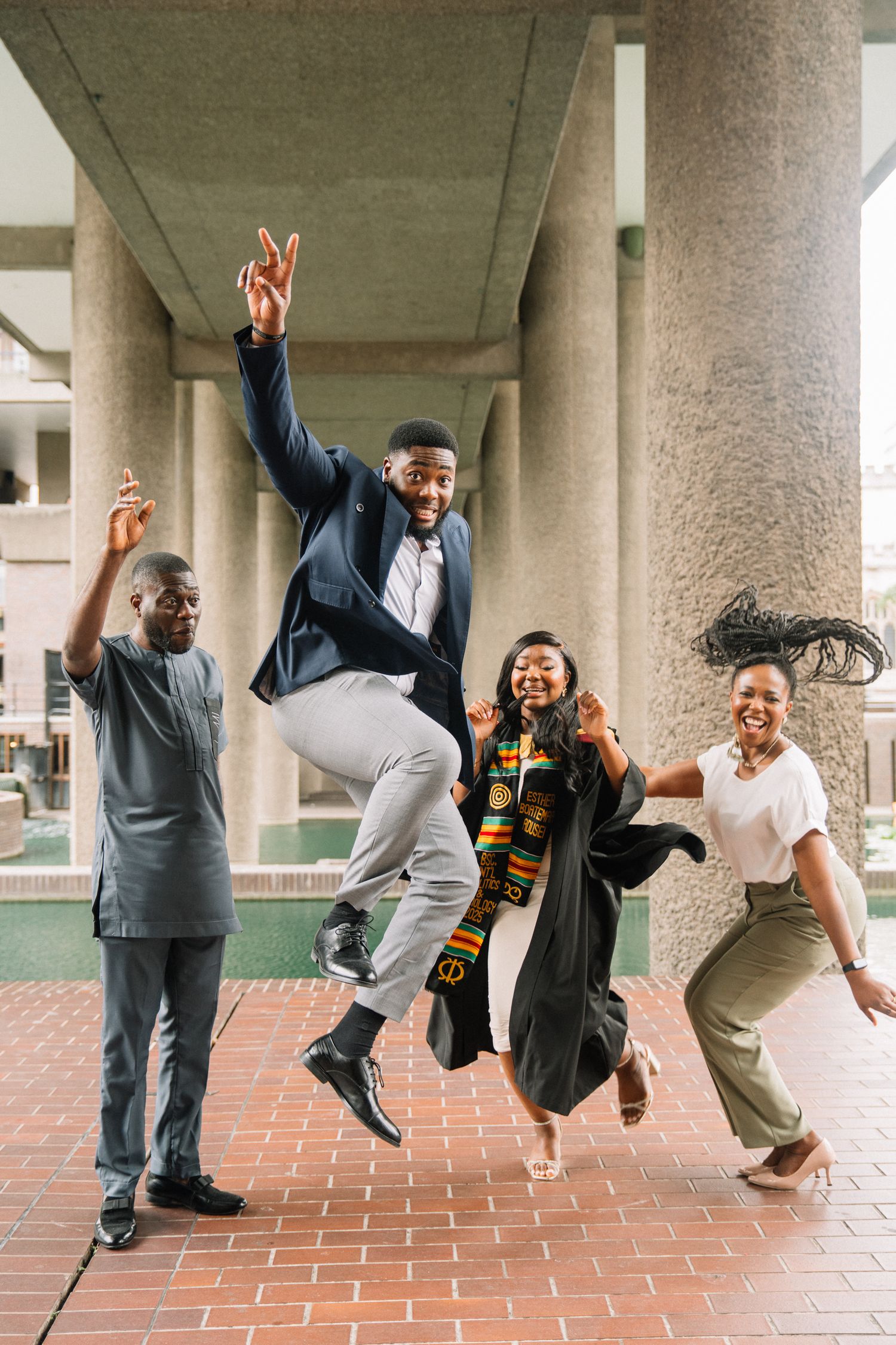 Joyful graduation celebration photos showing people jumping and posing under concrete columns.