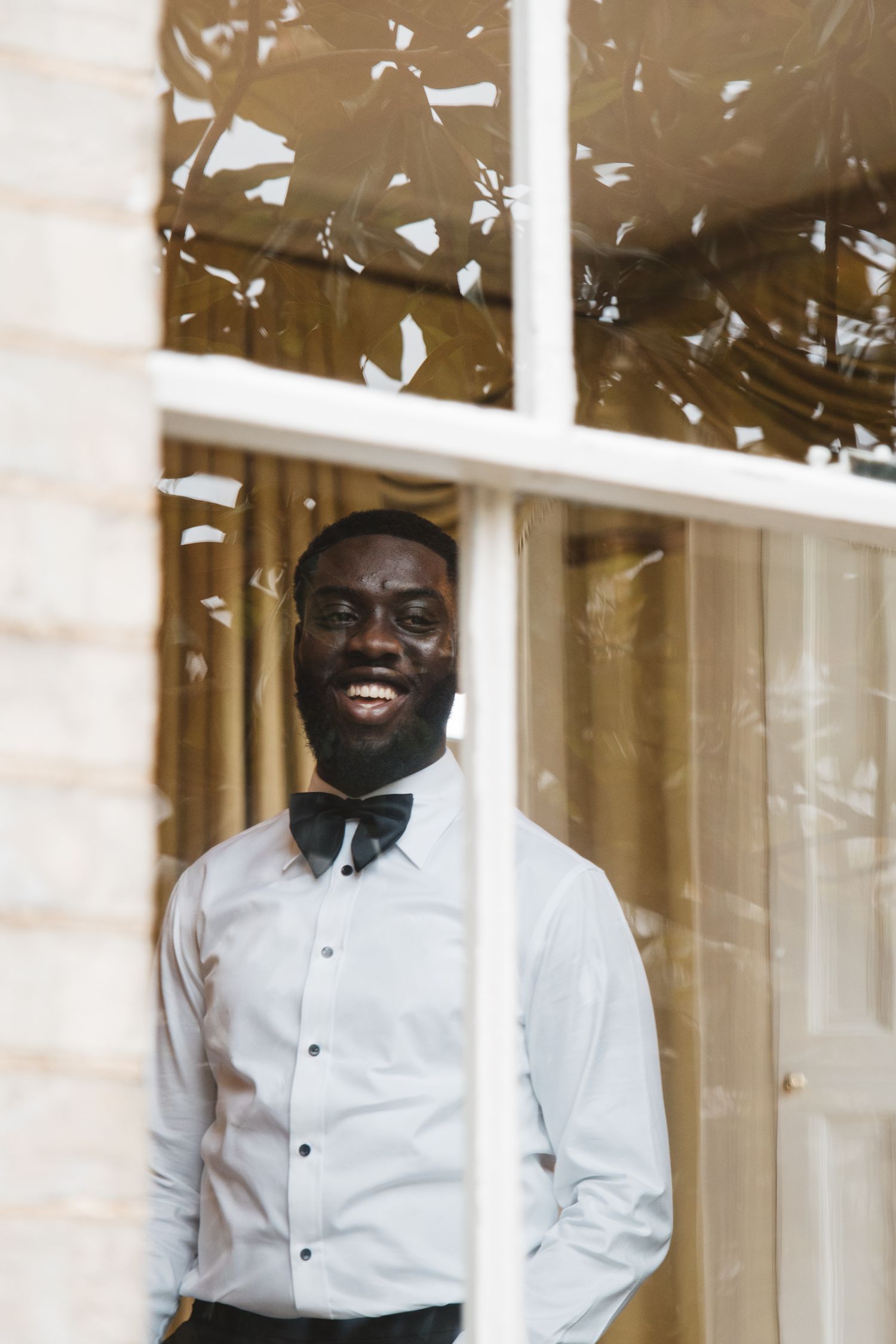 White confetti falls around a person in formal attire during a celebratory moment.