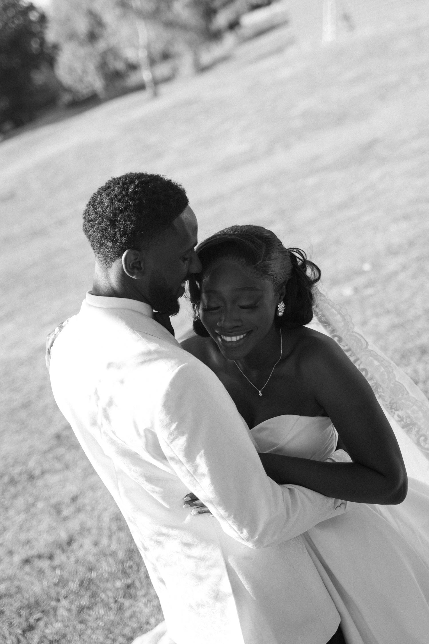 Candid black and white photo series capturing tender moments between a couple outdoors.