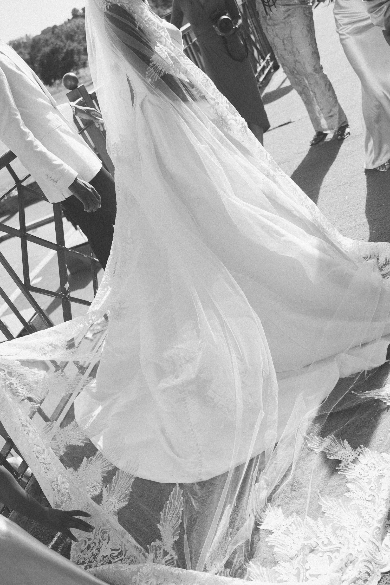 Black and white photo of flowing wedding dresses in motion.