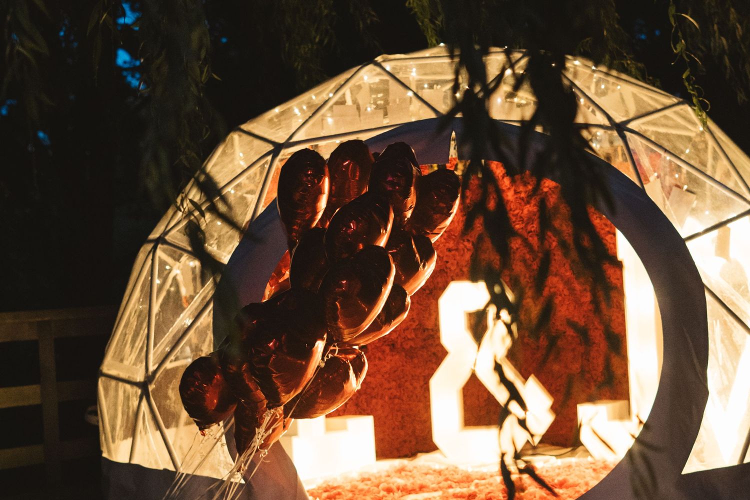 Illuminated decorative archways glowing with warm orange lighting in a dark setting.