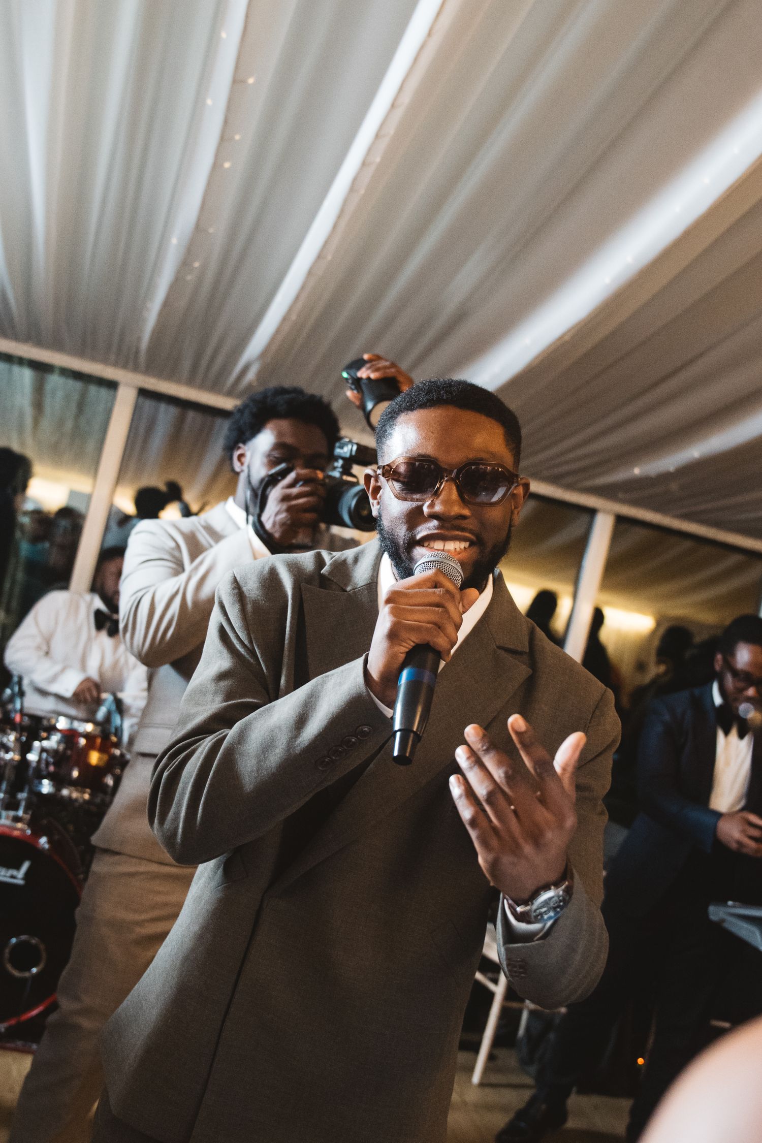 Wedding guests take photos with their phones during the reception.