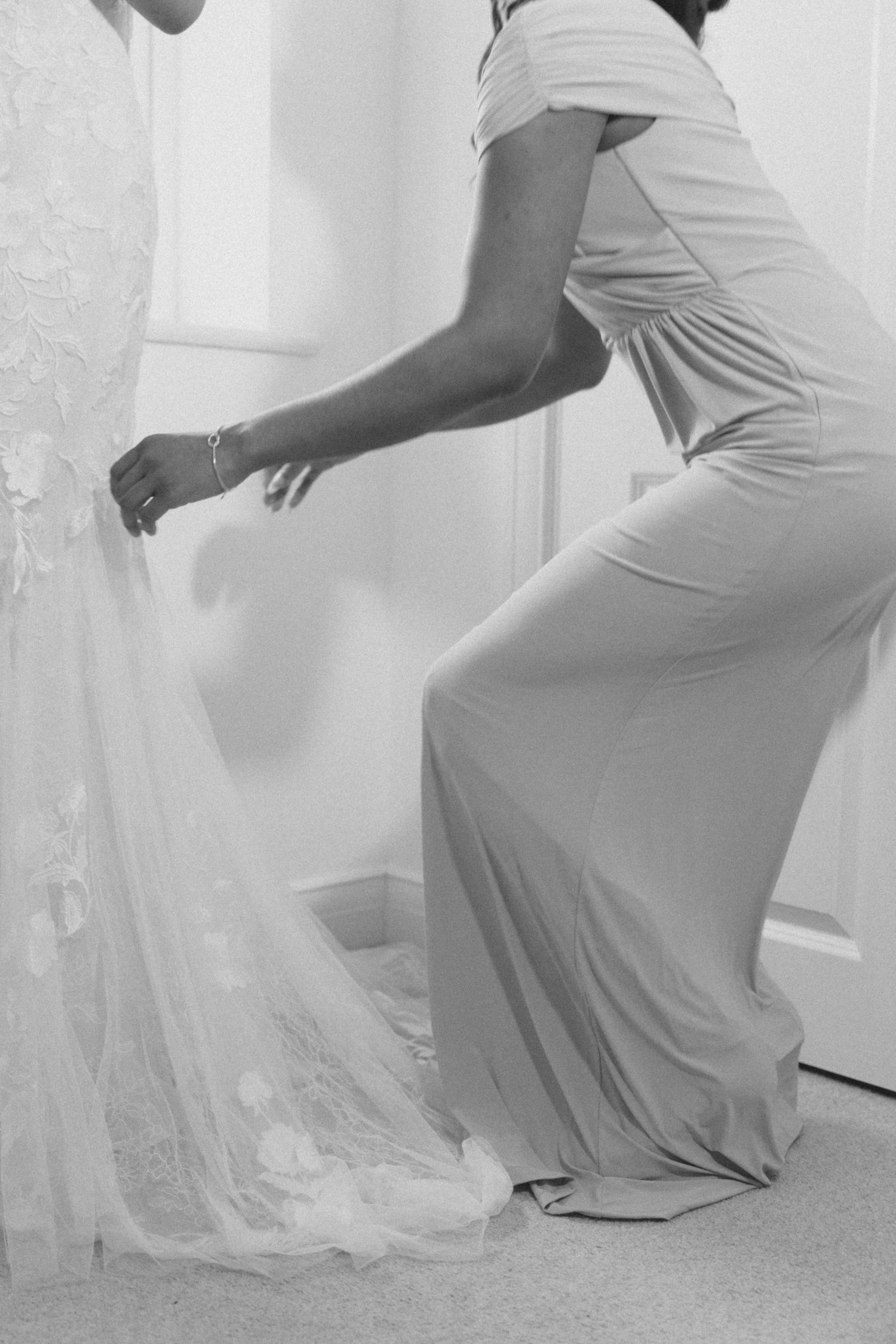 Flowing white dress movement captured in artistic black and white photography.