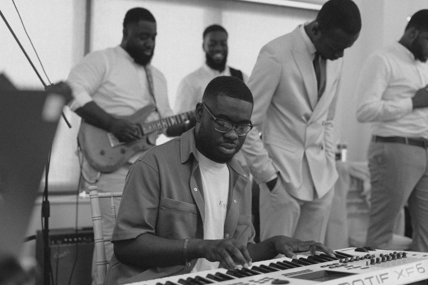 Musicians perform on keyboard instruments during a wedding reception.