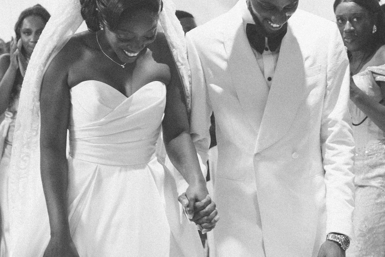 A tender moment captured in black and white with elegant white wedding attire.