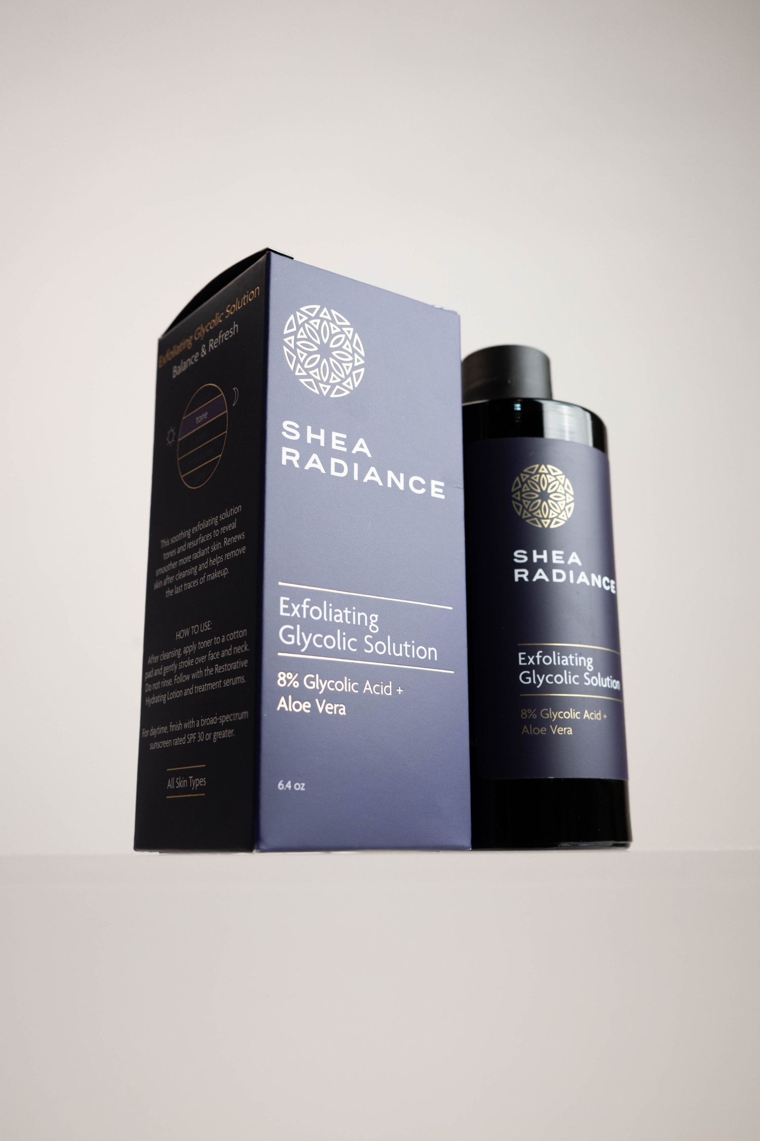 Shea Radiance Exfoliating Glycolic Solution with 8% Glycolic Acid and Aloe Vera, shown in box and bottle.