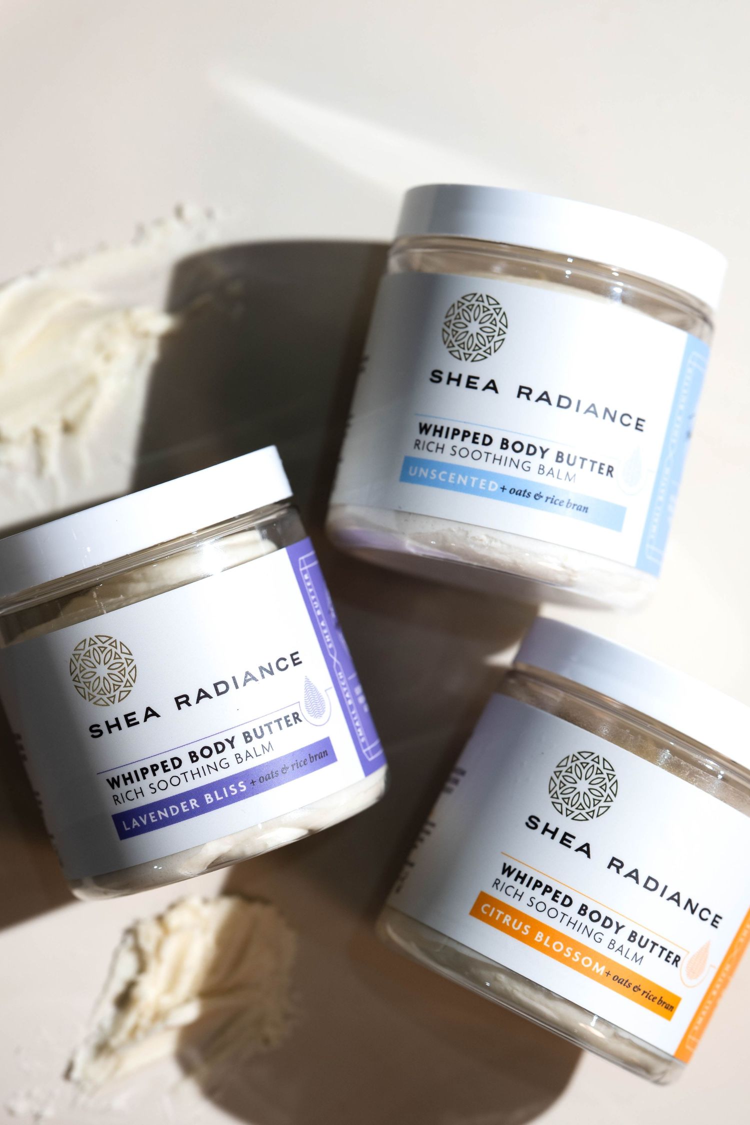 Three Shea Radiance Whipped Body Butter jars in Lavender Bliss, Unscented, and Citrus Blossom on a light background.