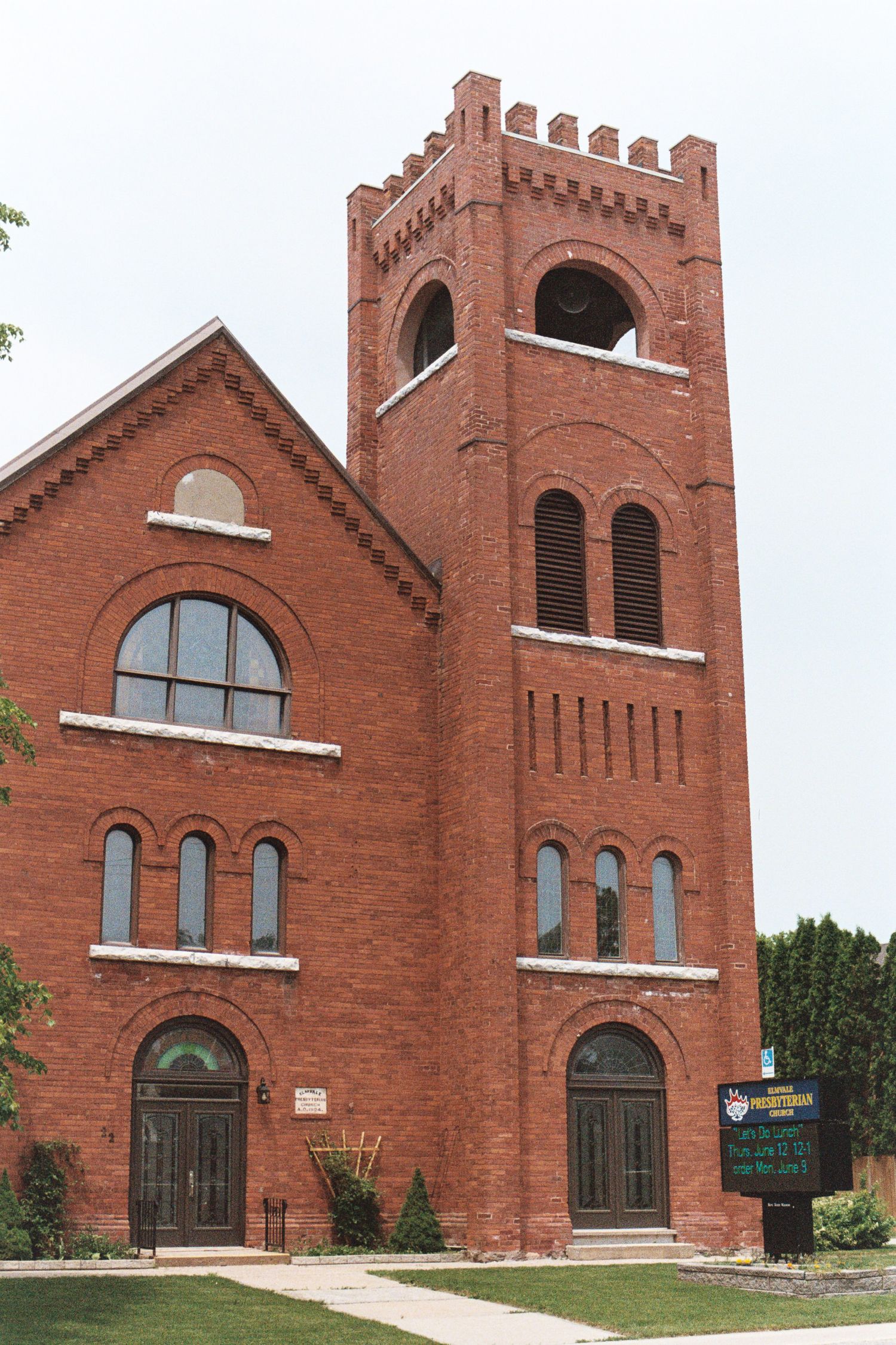 Multiple views of a red brick Gothic Revival church with arched windows and doorways showing architectural details.