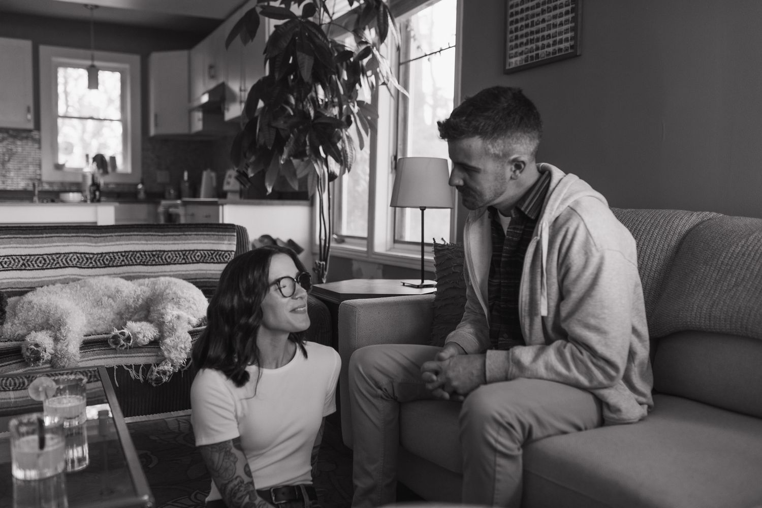 A series of monochromatic images showing people sitting and conversing in a home interior setting.