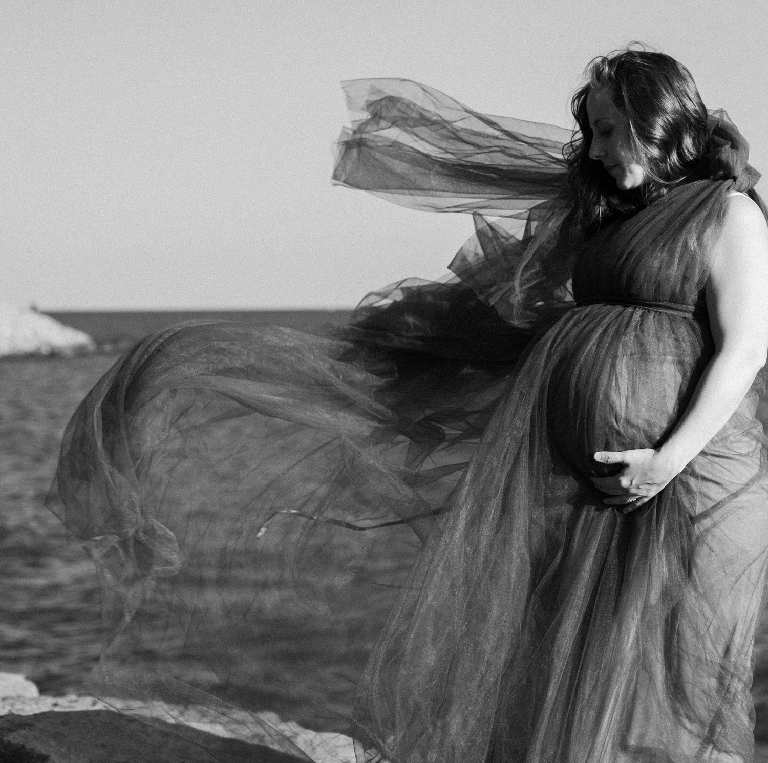 Artistic black and white photos of flowing fabric caught in wind against dramatic sky.