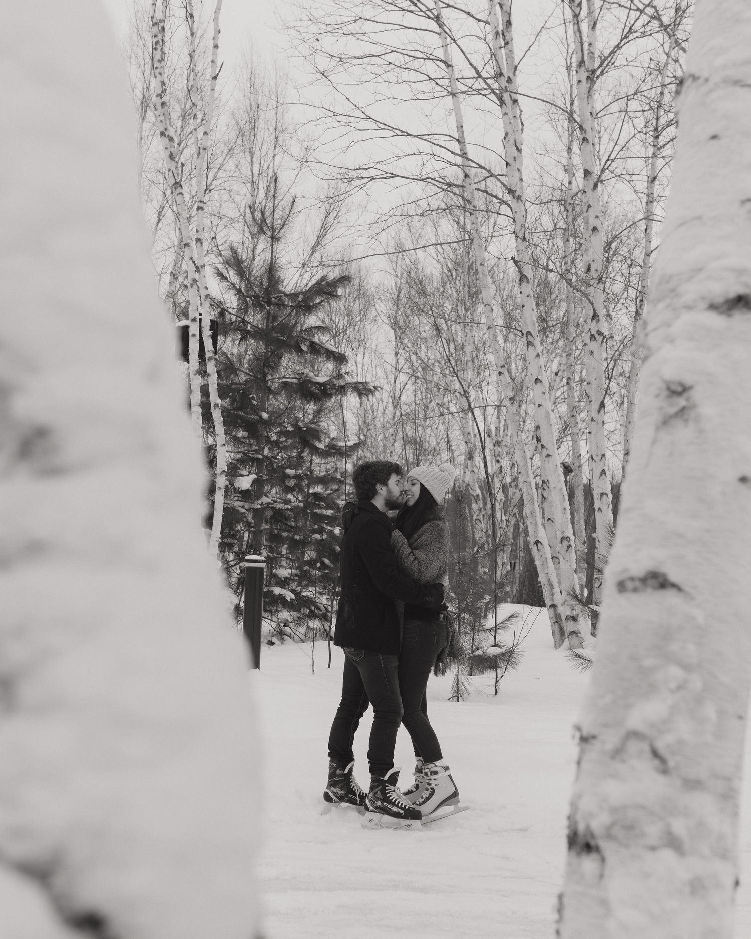 People enjoying winter activities in a snowy forest landscape.