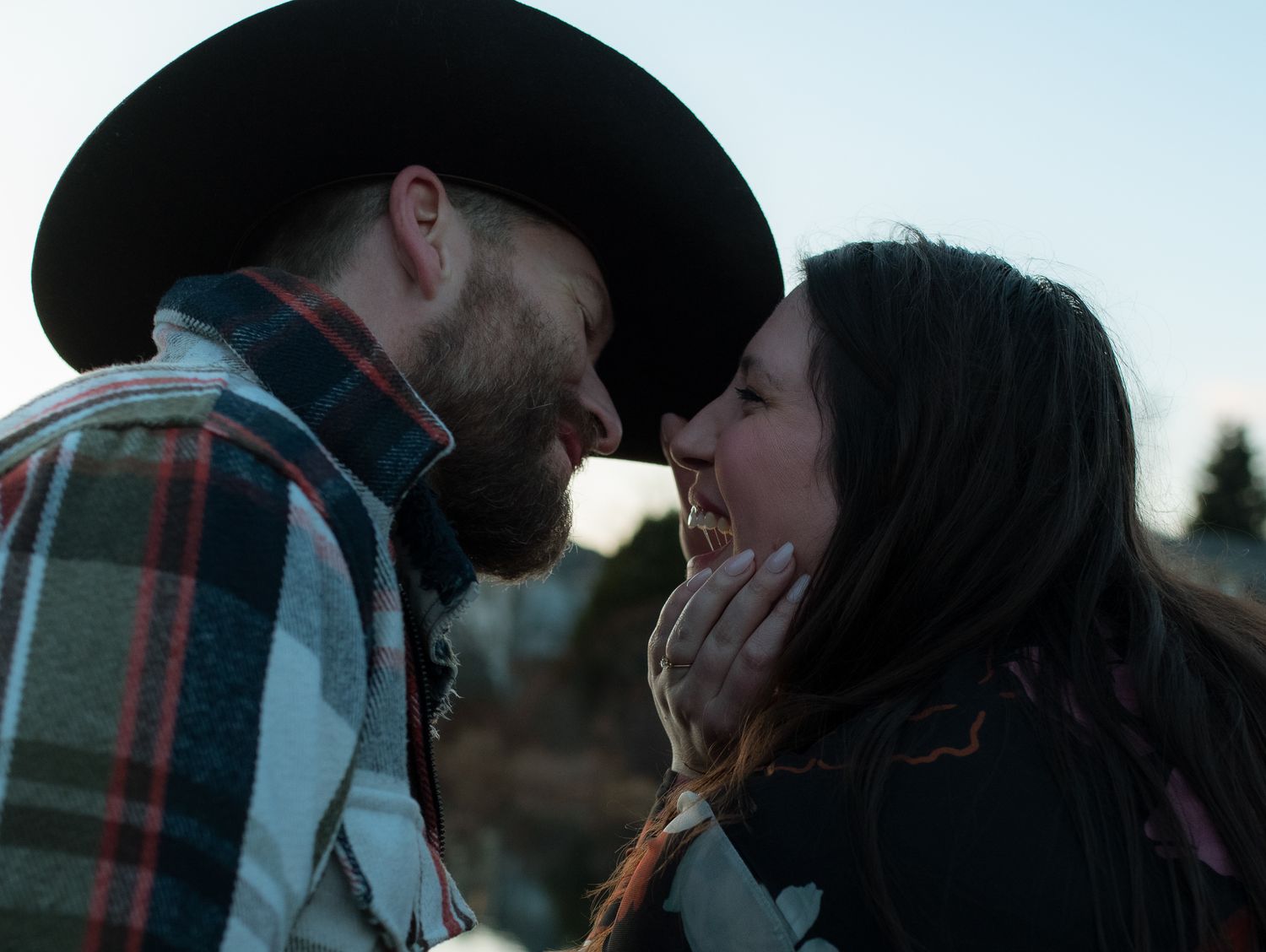 A romantic couple shares an intimate moment at sunset, with multiple frames showing them embracing and kissing.