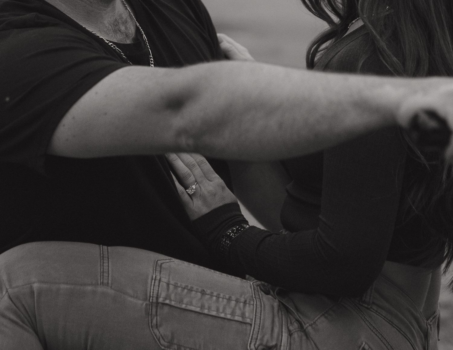 Close-up details of casual clothing and accessories in black and white.