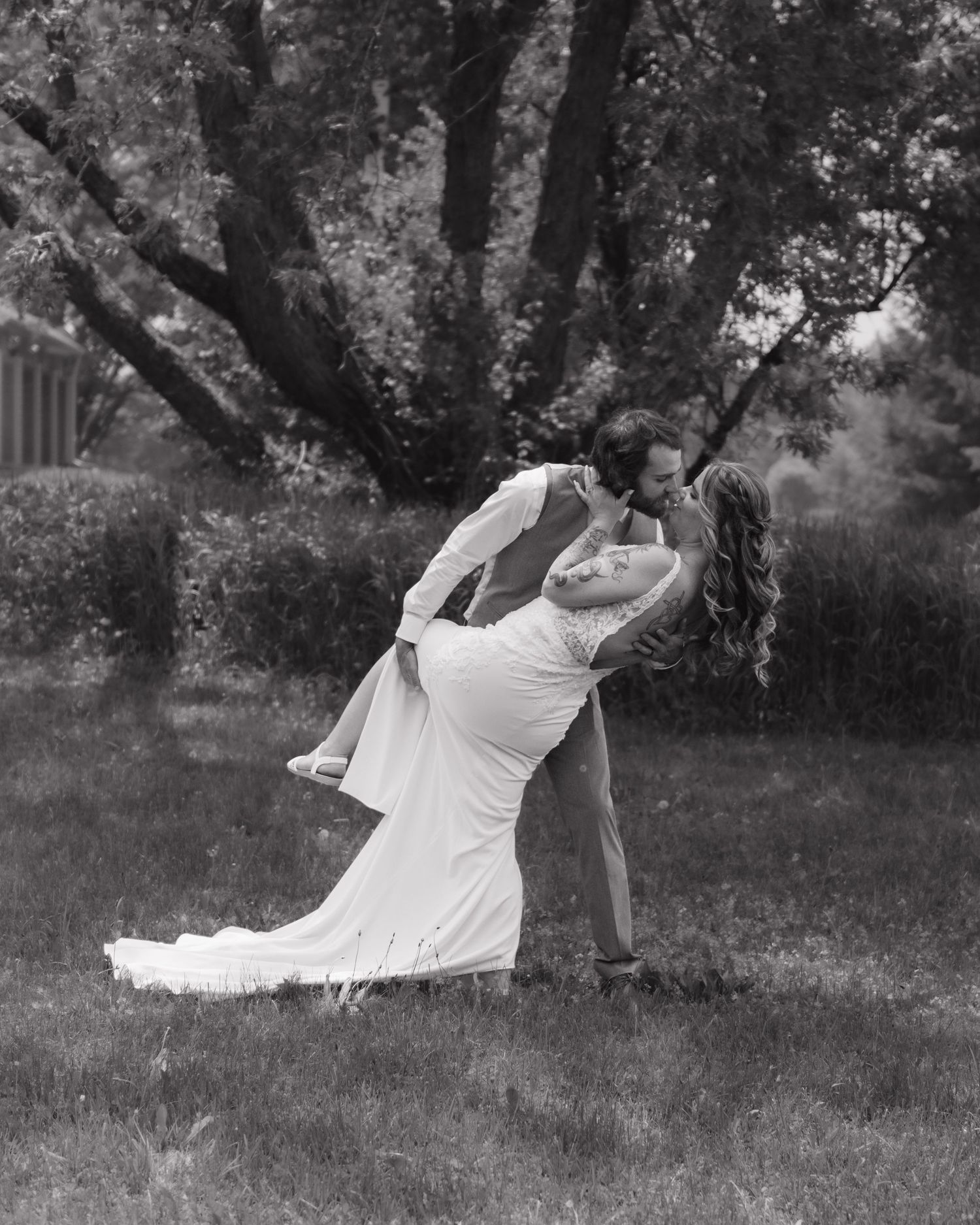 A sequence of black and white photos shows someone in white clothing dancing gracefully in a park setting.