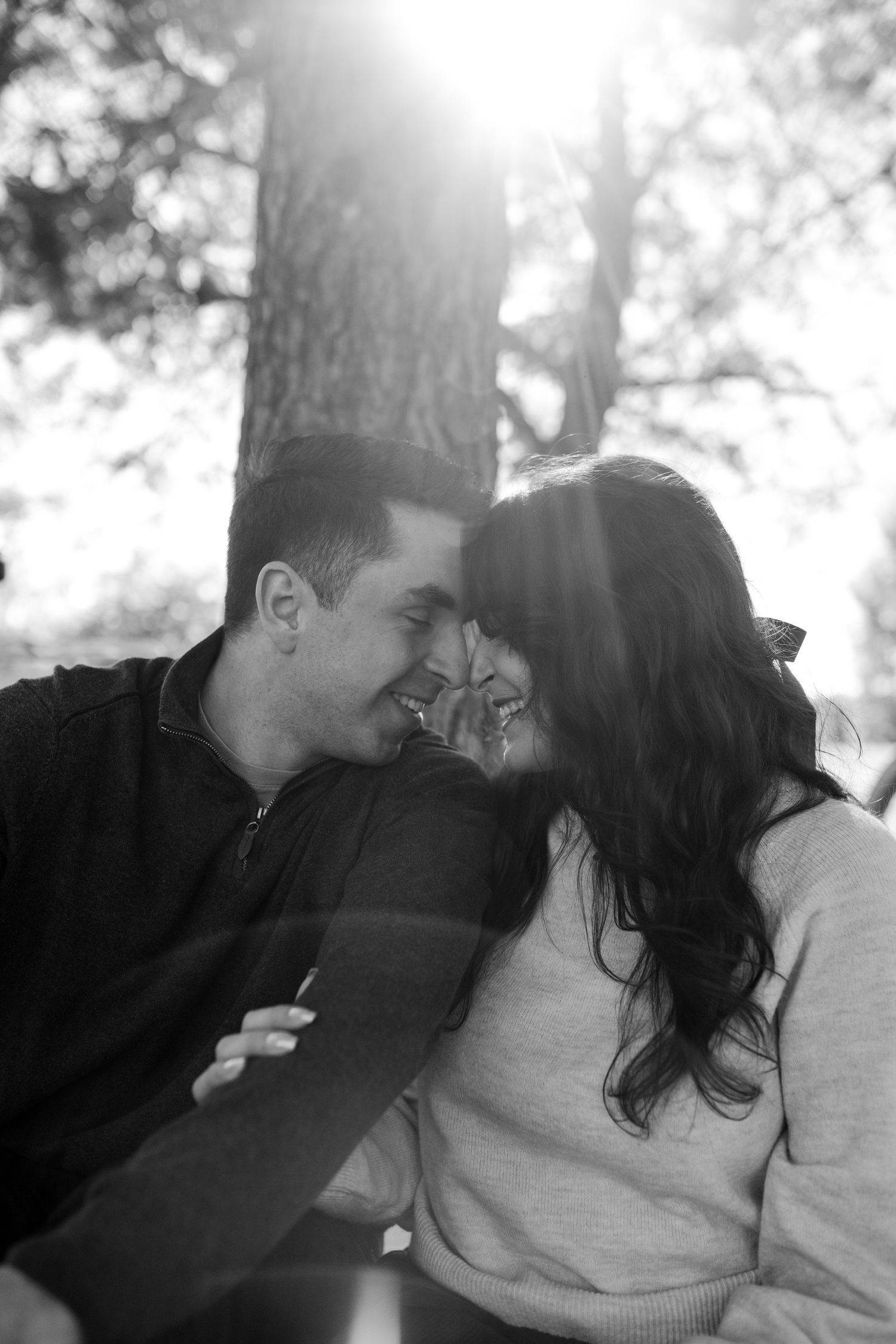 A romantic black and white photo sequence shows a couple sharing tender kisses in natural lighting.