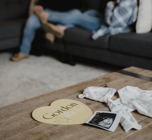 Paper tissues and a heart-shaped note scattered on a wooden table surface.