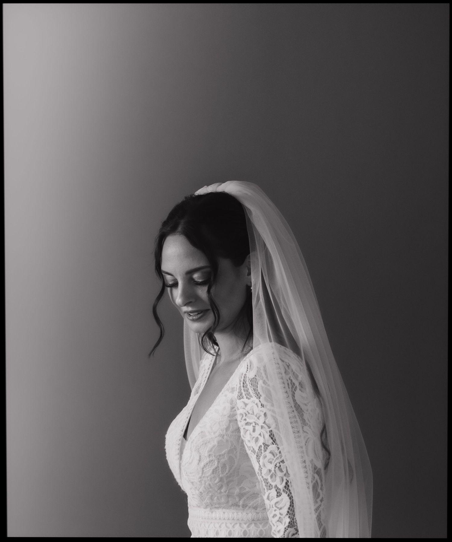 An elegant bridal portrait with delicate lace details and veil.