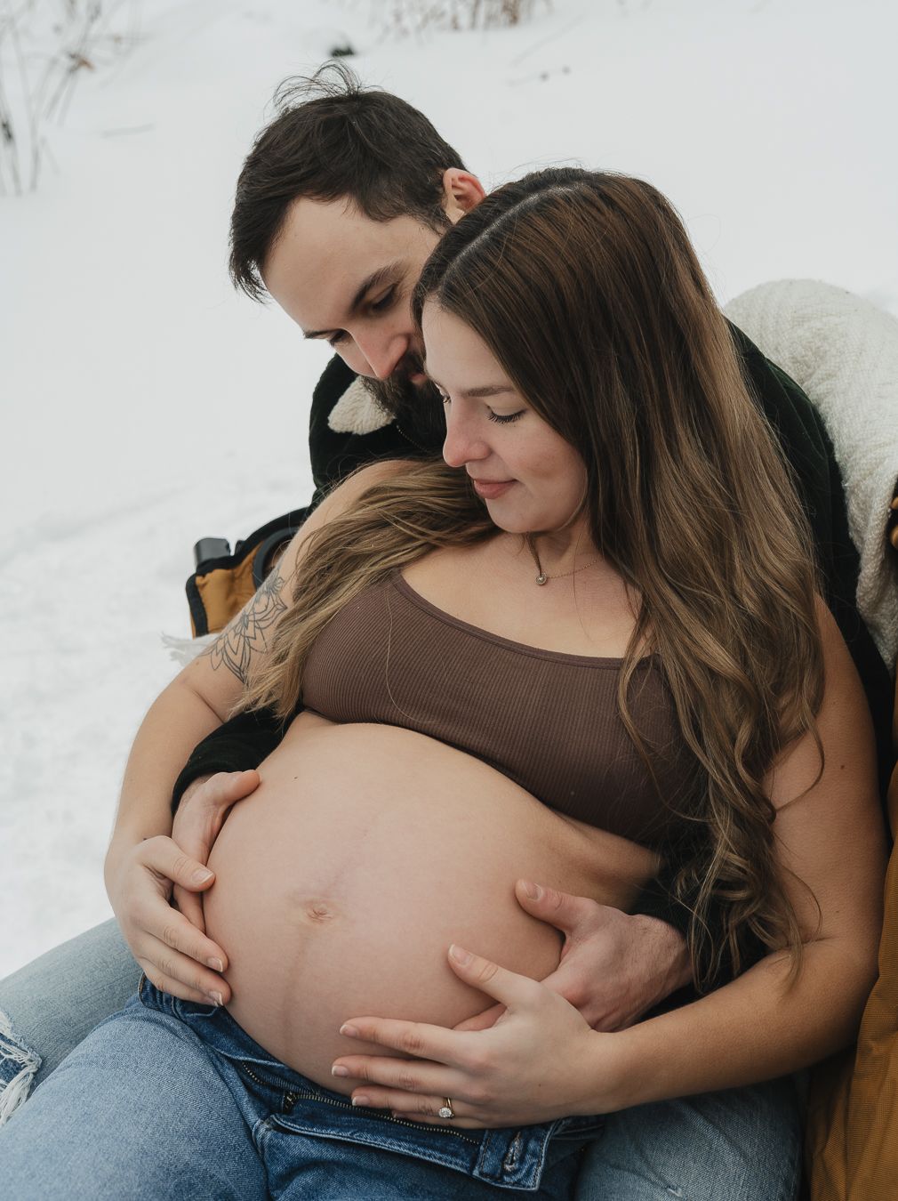Two people share an intimate moment while looking at an ultrasound scan.