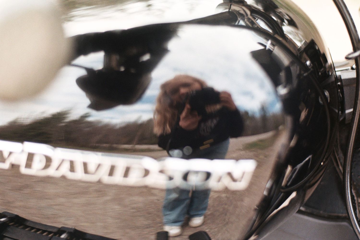 Close-up detail of a black Harley-Davidson motorcycle with chrome accents.