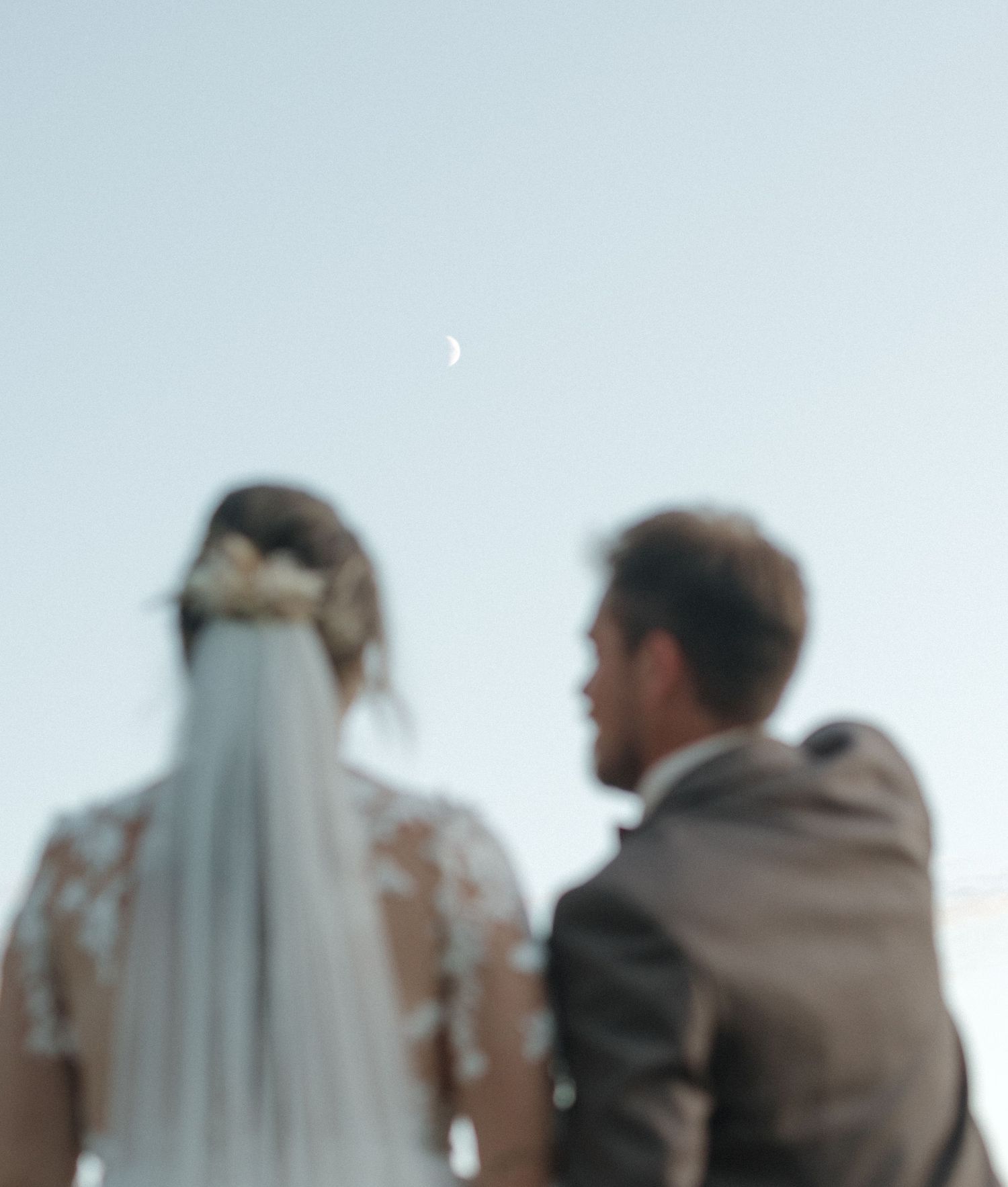 A couple shares an intimate moment during their outdoor wedding ceremony.