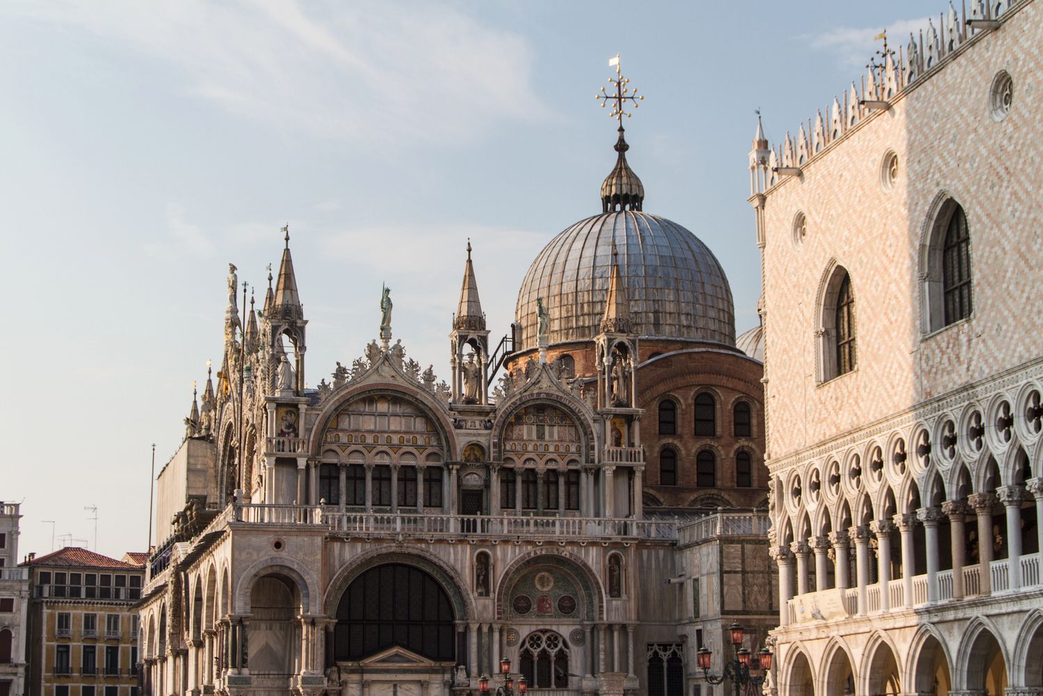 St. Mark's Basilica and Doge's Palace in Venice, Italy, showcasing stunning Byzantine and Gothic architecture under a clear sky.