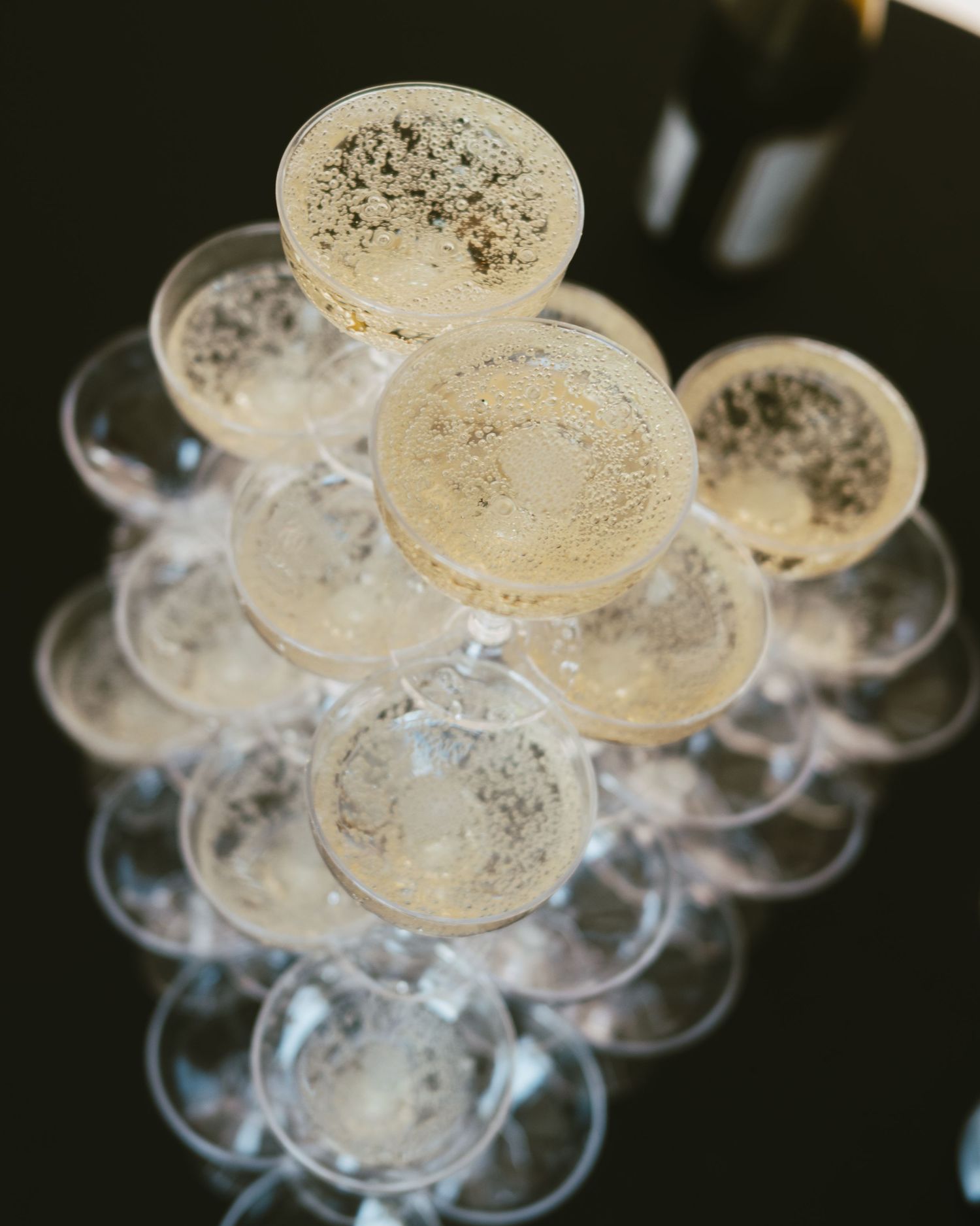 Close-up of vintage champagne coupes arranged in classic tower formation.