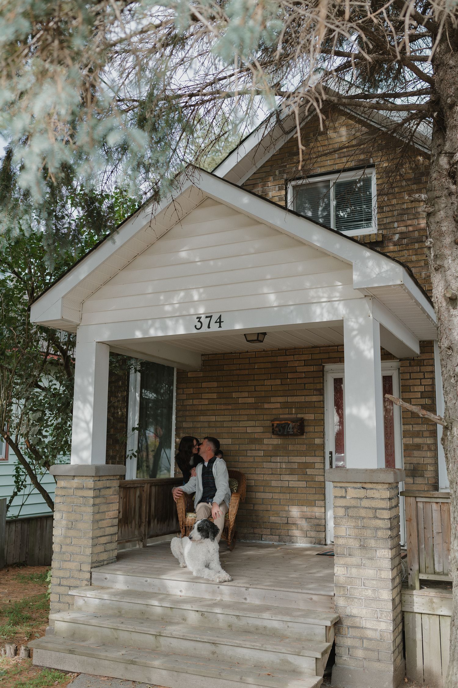 A sequence of photos showing people sitting on a white-painted front porch with brick columns at house number 374.