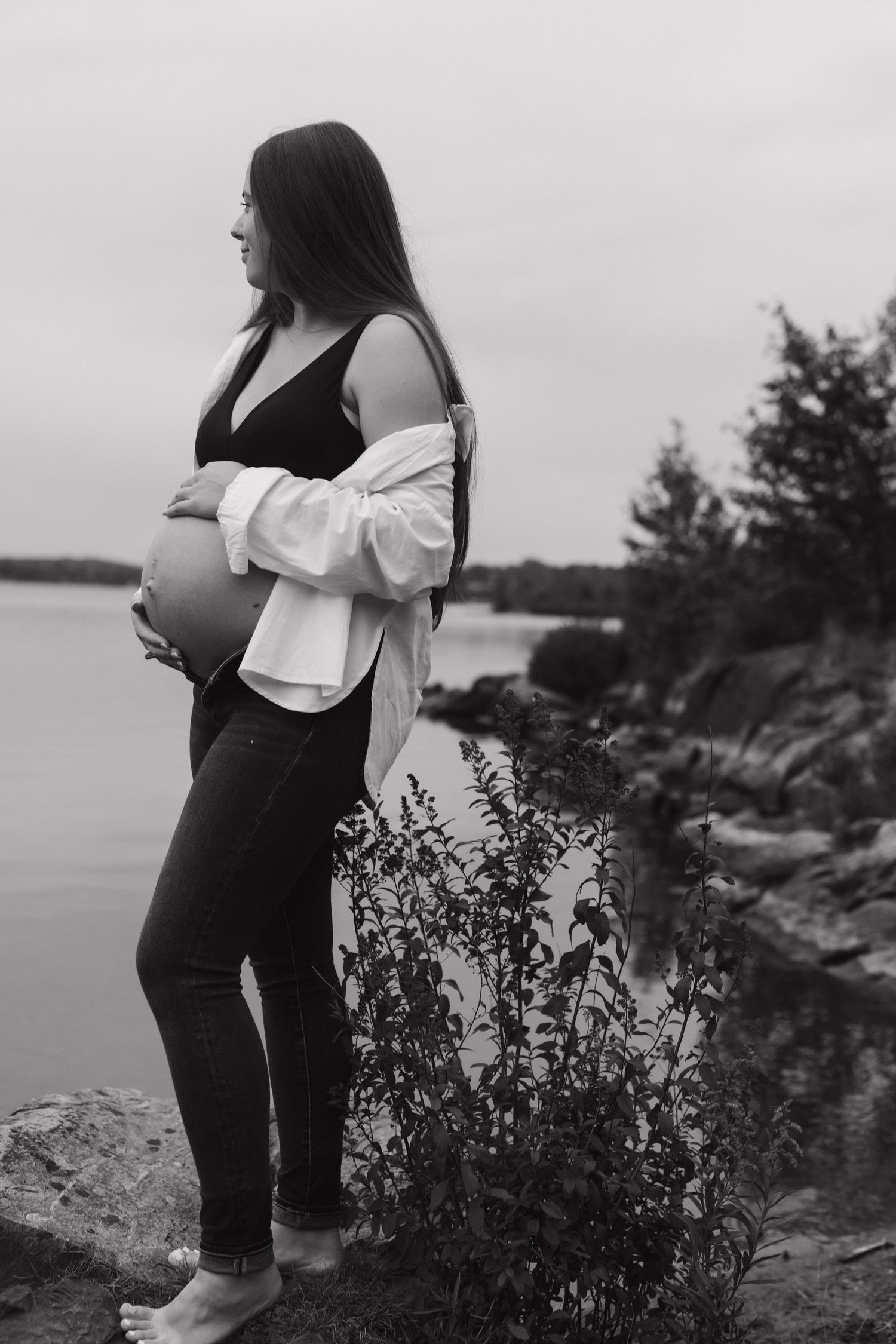 A black and white series of photos showing someone in dark clothing against a rocky coastal landscape.