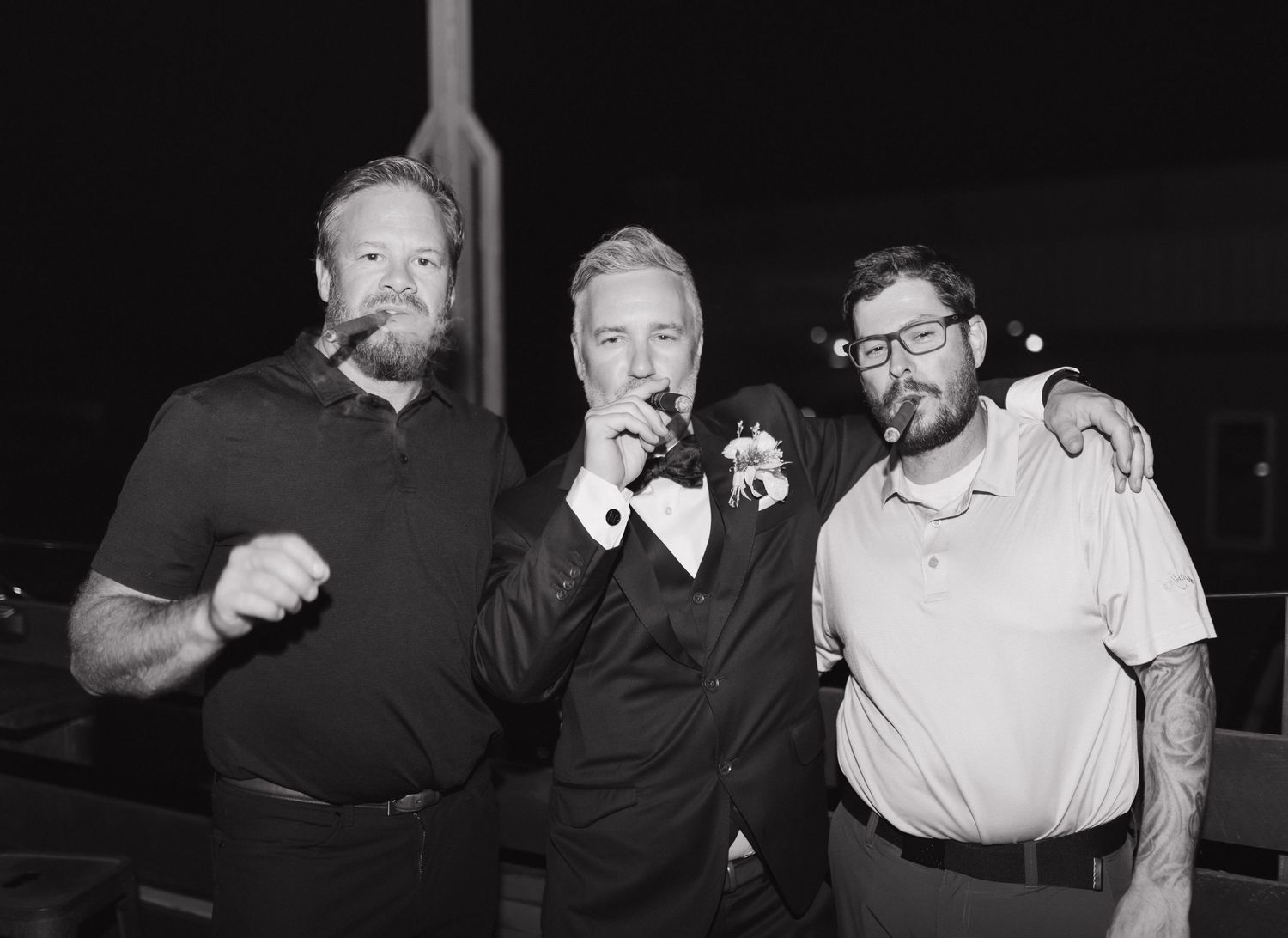 Three friends enjoying drinks and conversation at night.