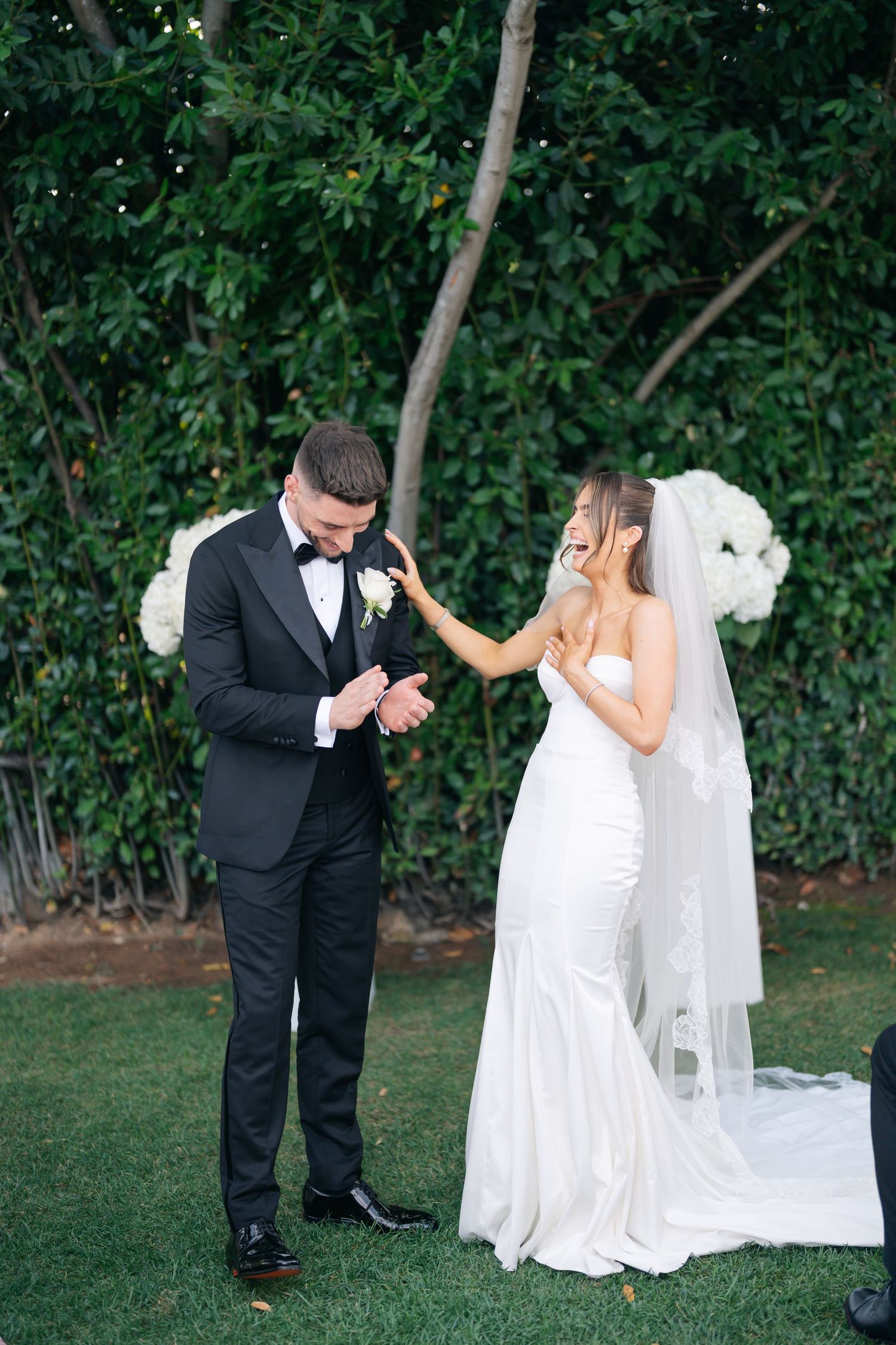 Playful wedding photo sequence showing couple's emotional first look in a garden setting.