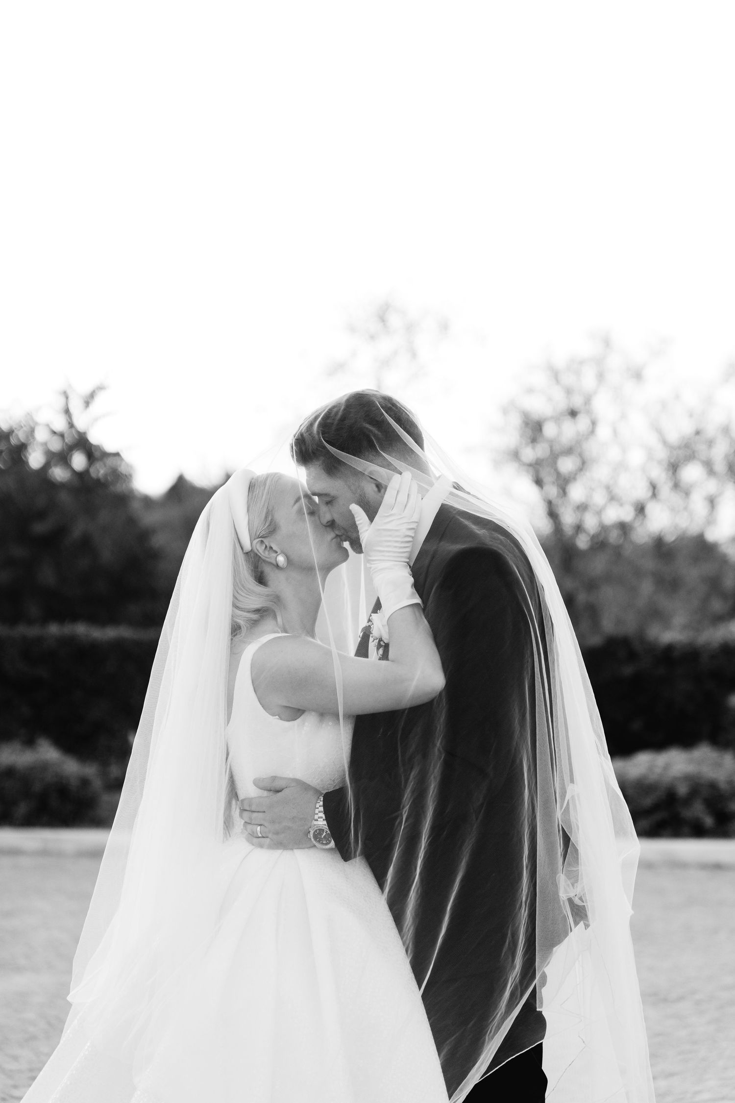 Black and white romantic wedding portrait showing an intimate dip pose.