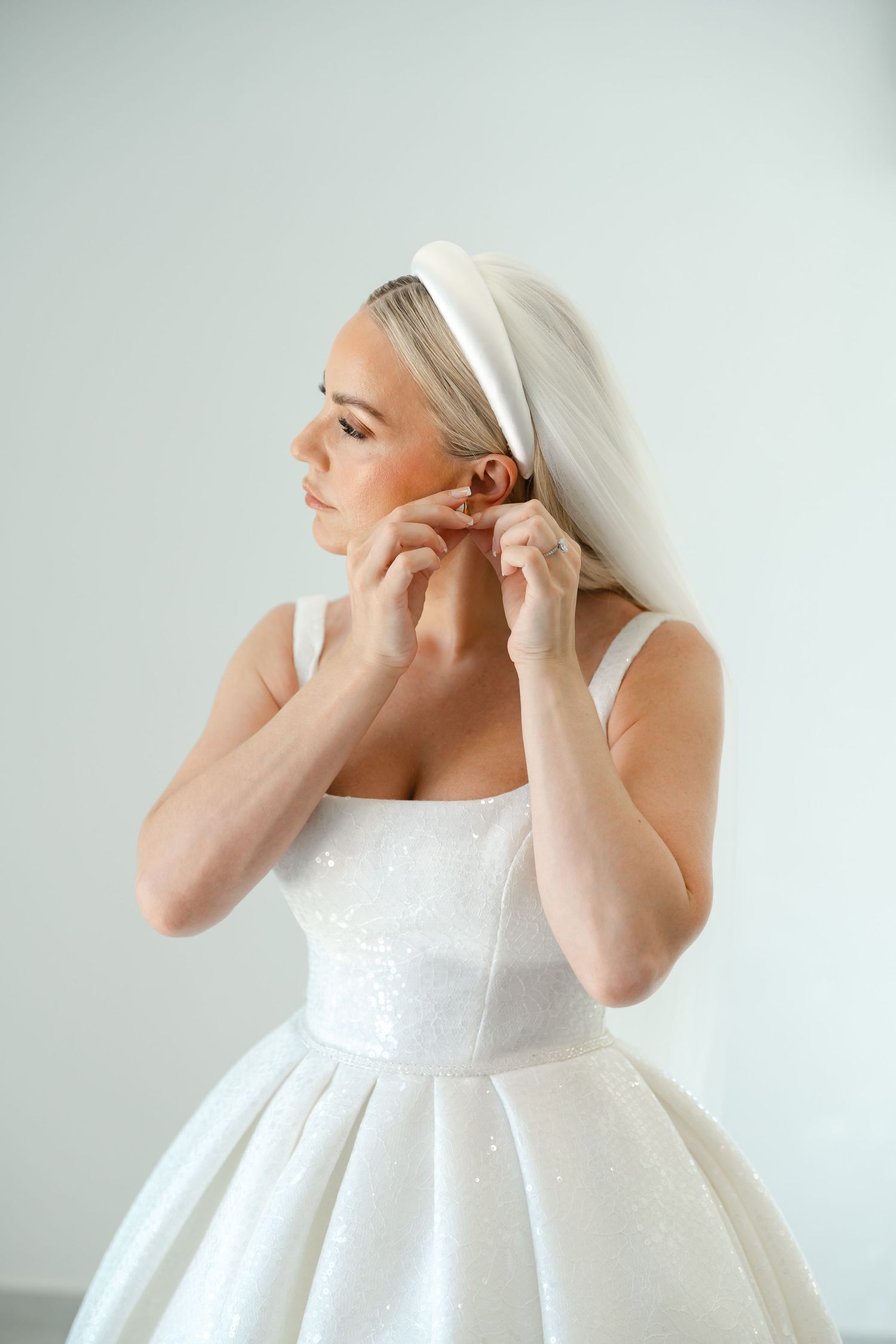 Close-up shots of bride putting on earrings while getting ready.
